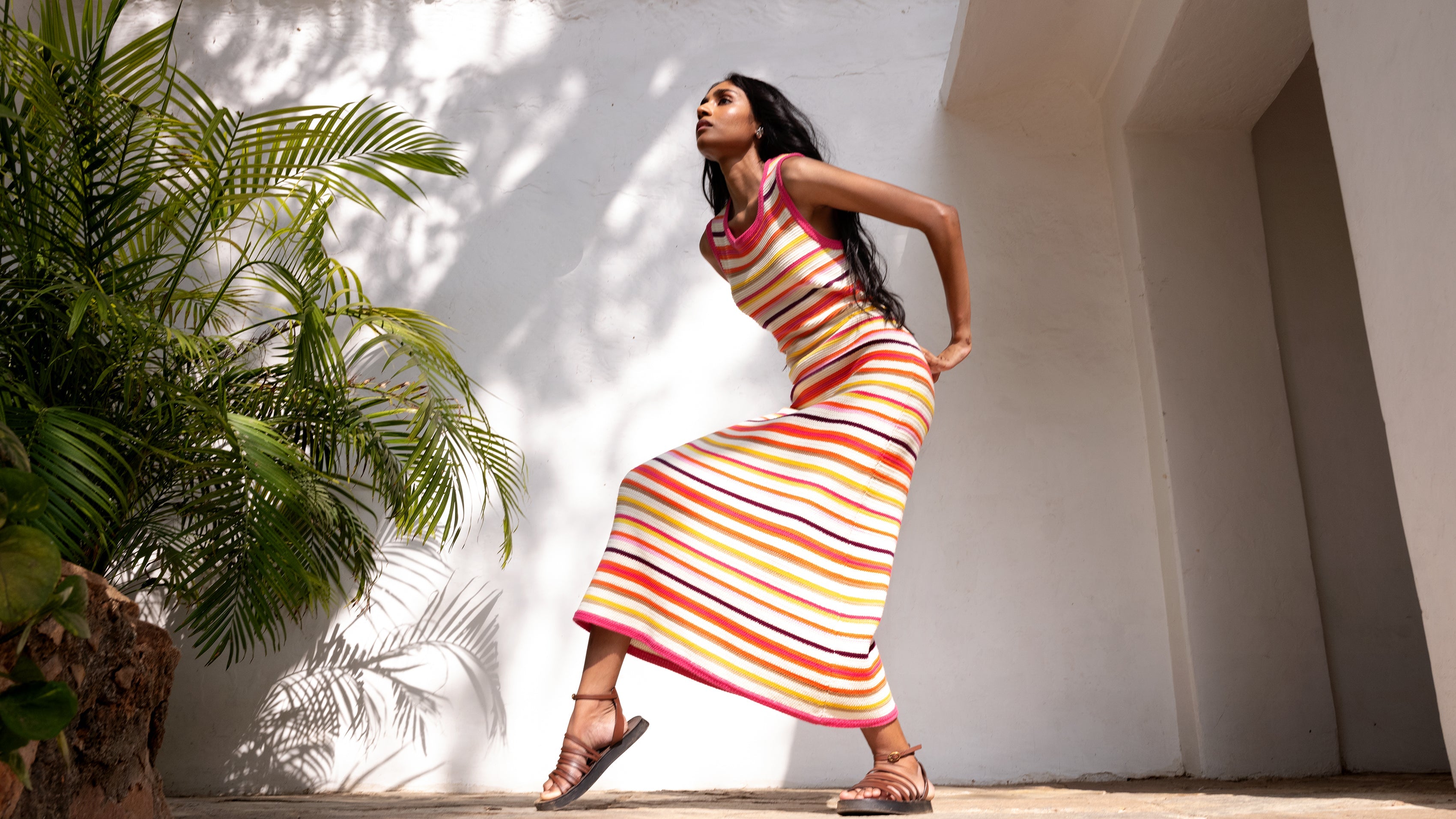 Woman wearing full length knitted dress.