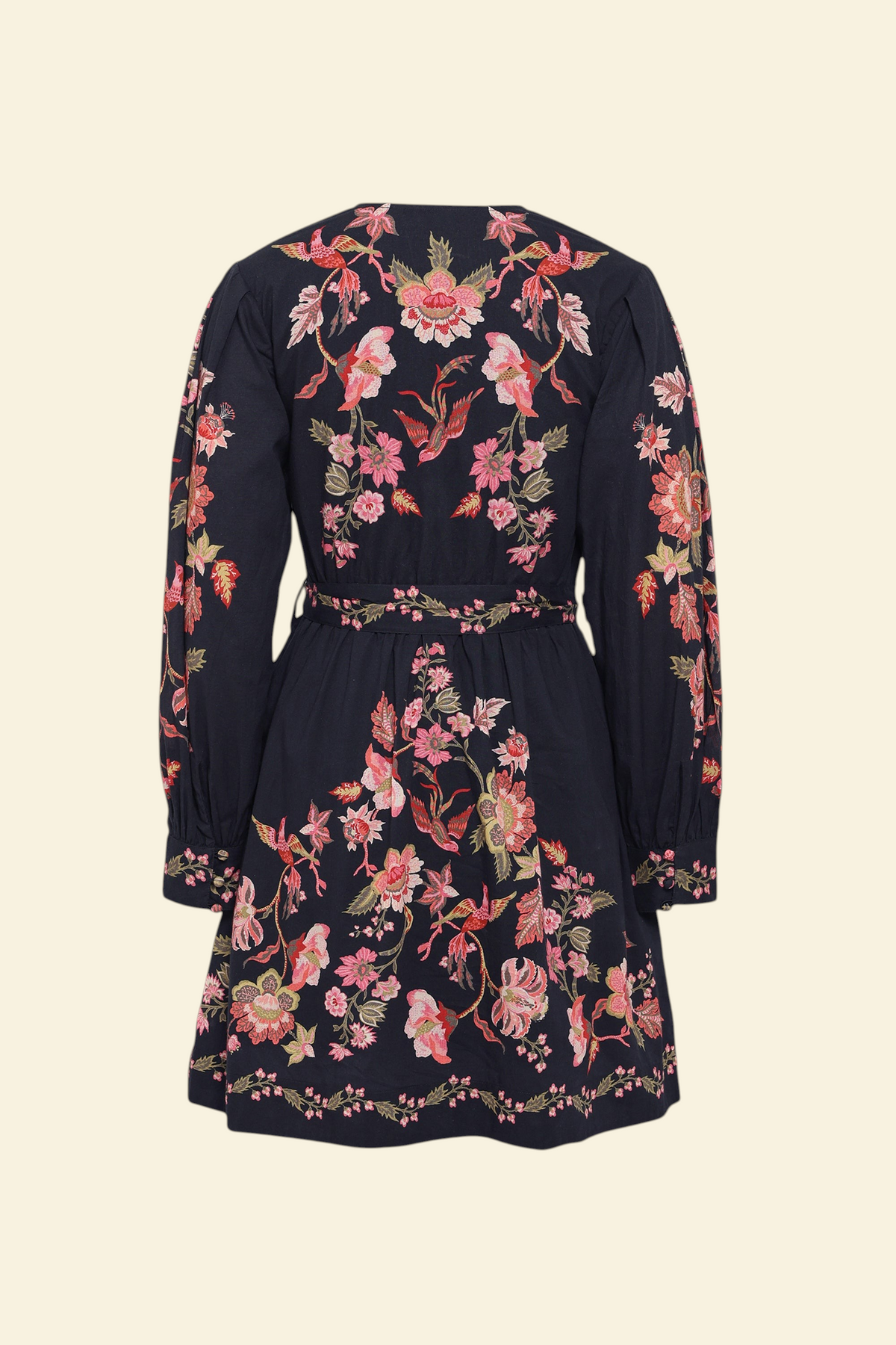 Back view of the Anne dress in Chintz print. It features long sleeves, an elasticated waist, fabric-covered buttons, a fabric belt, and side-seam pockets.