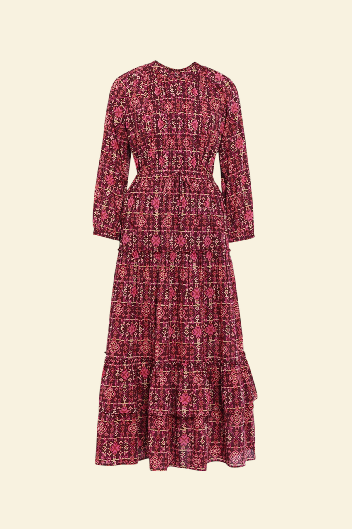 Banjanan Bazaar dress in mahogany cotton voile with a geometric needlepoint floral print, long sleeves, and tiers.