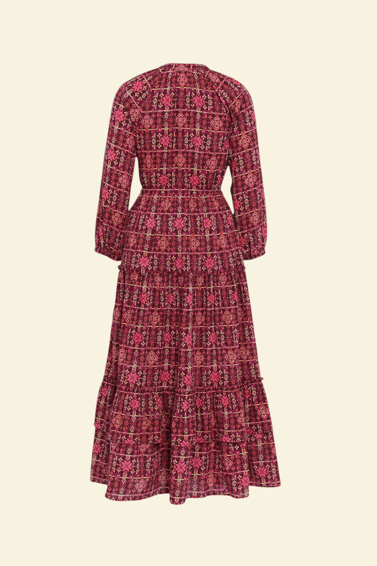 Banjanan Bazaar dress in mahogany cotton voile with a geometric needlepoint print, long sleeves, and tiered skirt.