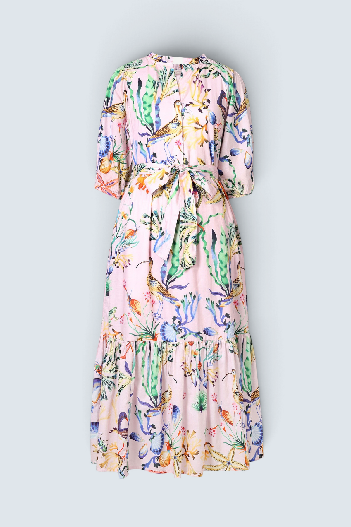 Banjanan Betty dress in pink cotton voile with Tidepool shell and sea life print, featuring a tie waist and pockets.