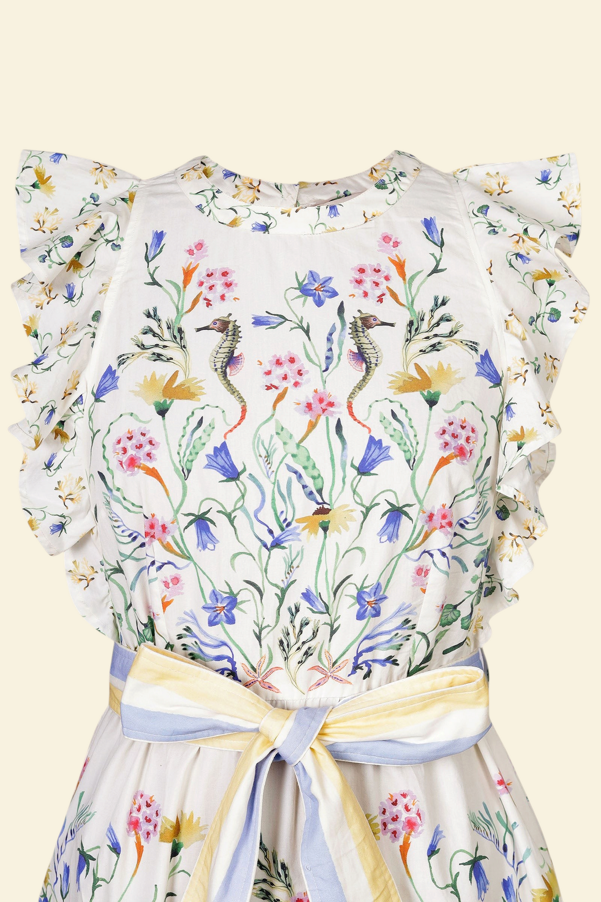Banjanan Bulbul dress in Tidepool Grotto print with ruffled shoulders, seahorse floral pattern, and striped belt.