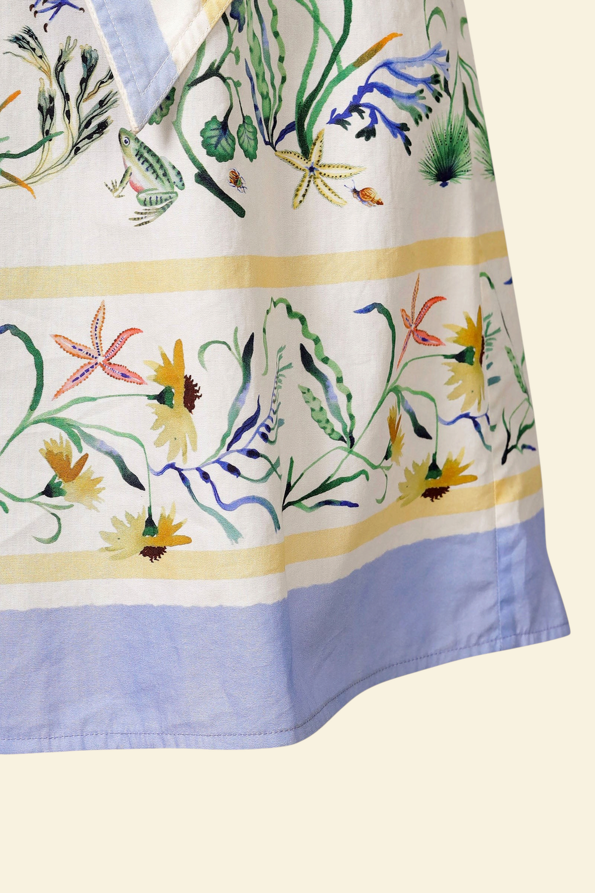 Banjanan Bulbul dress in Tidepool Grotto print featuring seahorses, wildflowers, and blue and yellow striped trim.