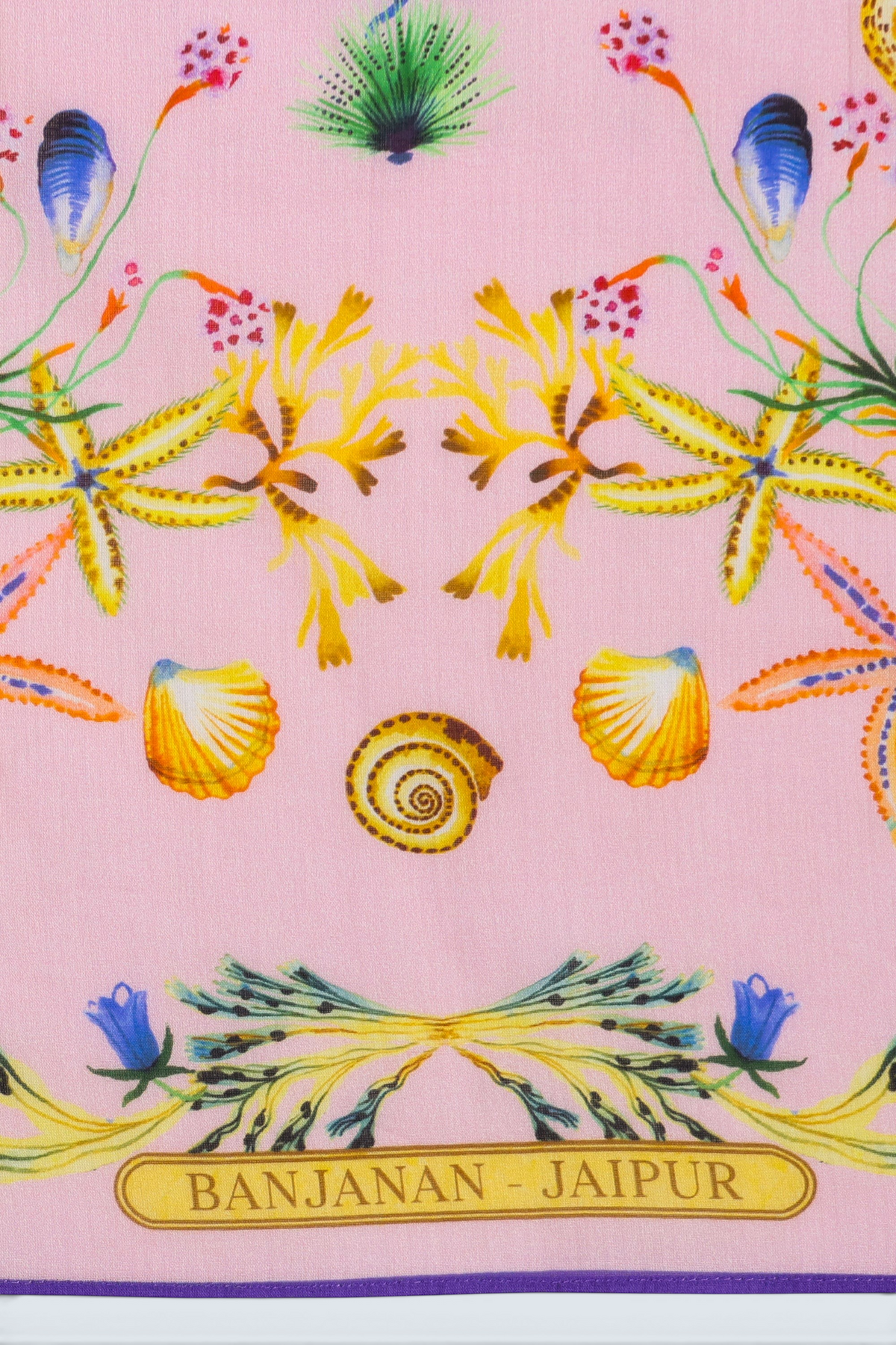 Close up detail of flat lay of Carolina scarf featuring Tidepool print with starfish, seahorses, and shells in ocean-inspired tones.
