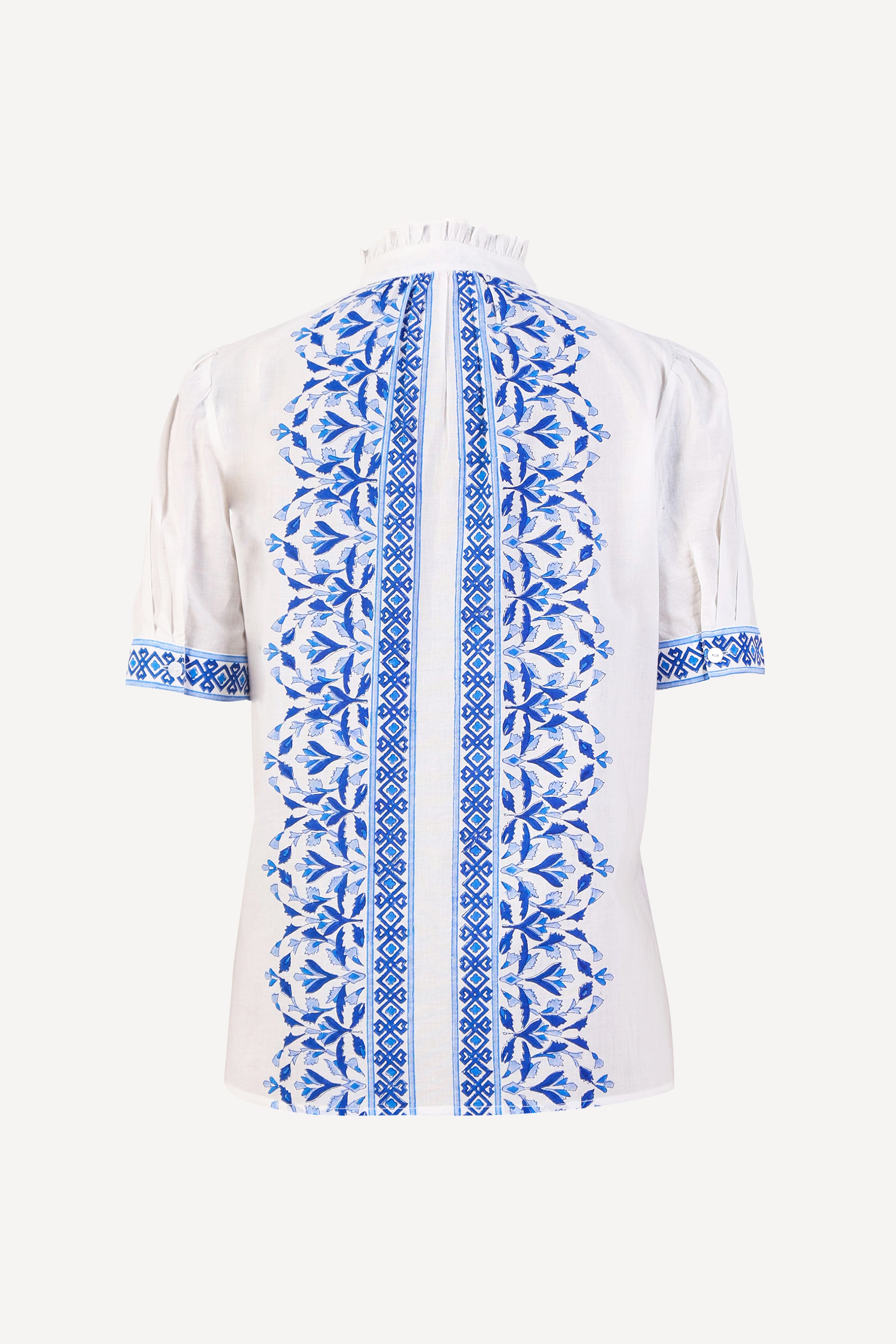 Back view the Christina button-up shirt with geometric floral block print, frilled collar, gathered neckline, and puff sleeves.