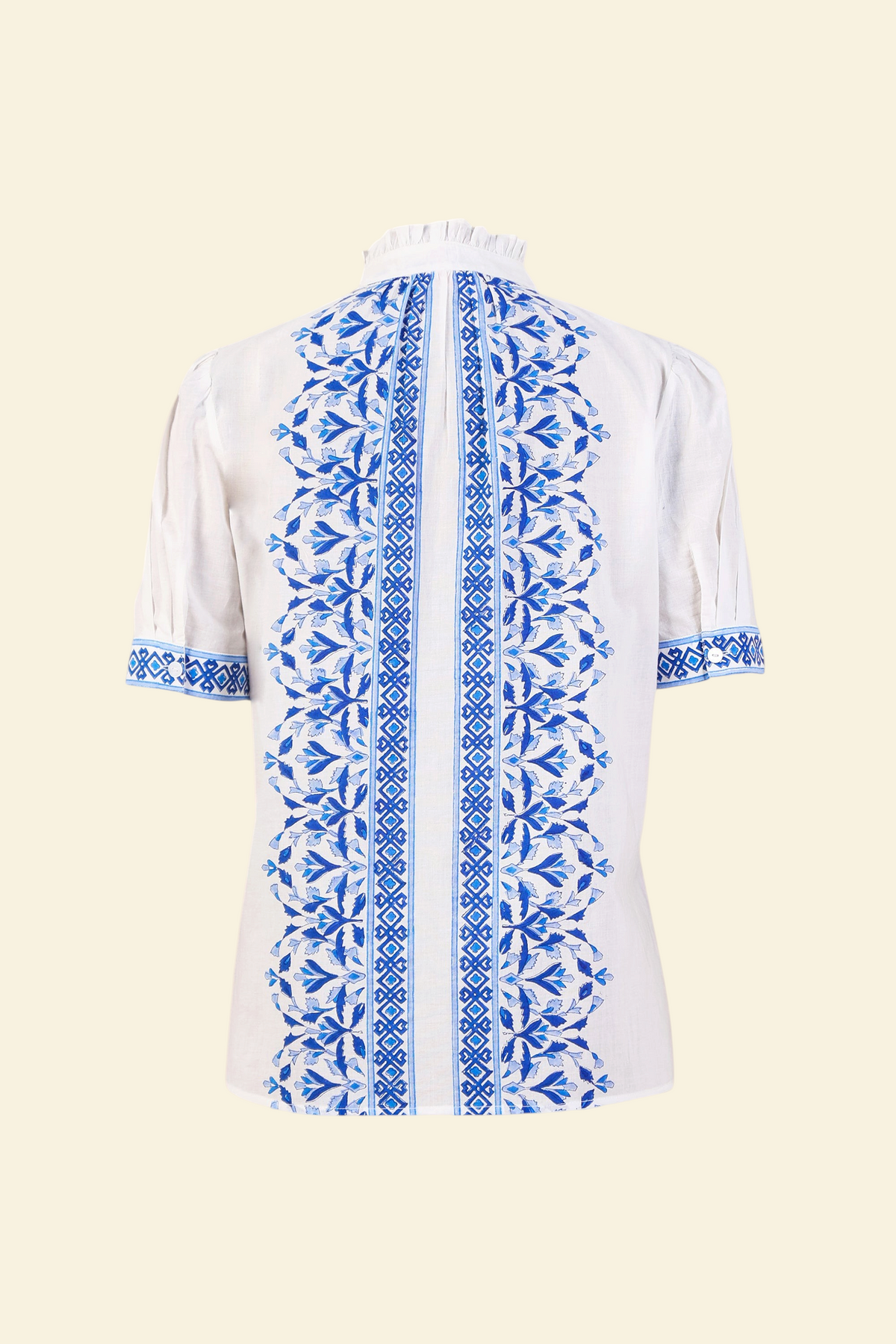 Back view the Christina button-up shirt with geometric floral block print, frilled collar, gathered neckline, and puff sleeves.