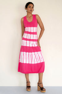 Model posing in front view wearing a sleeveless and calf length Genoa tie dyed dress. Model posing in front view wearing a sleeveless and calf length Genoa tie dyed dress.