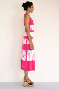 Side view of model wearing a sleeveless and calf length Genoa tie dyed dress. Side view of model wearing a sleeveless and calf length Genoa tie dyed dress.
