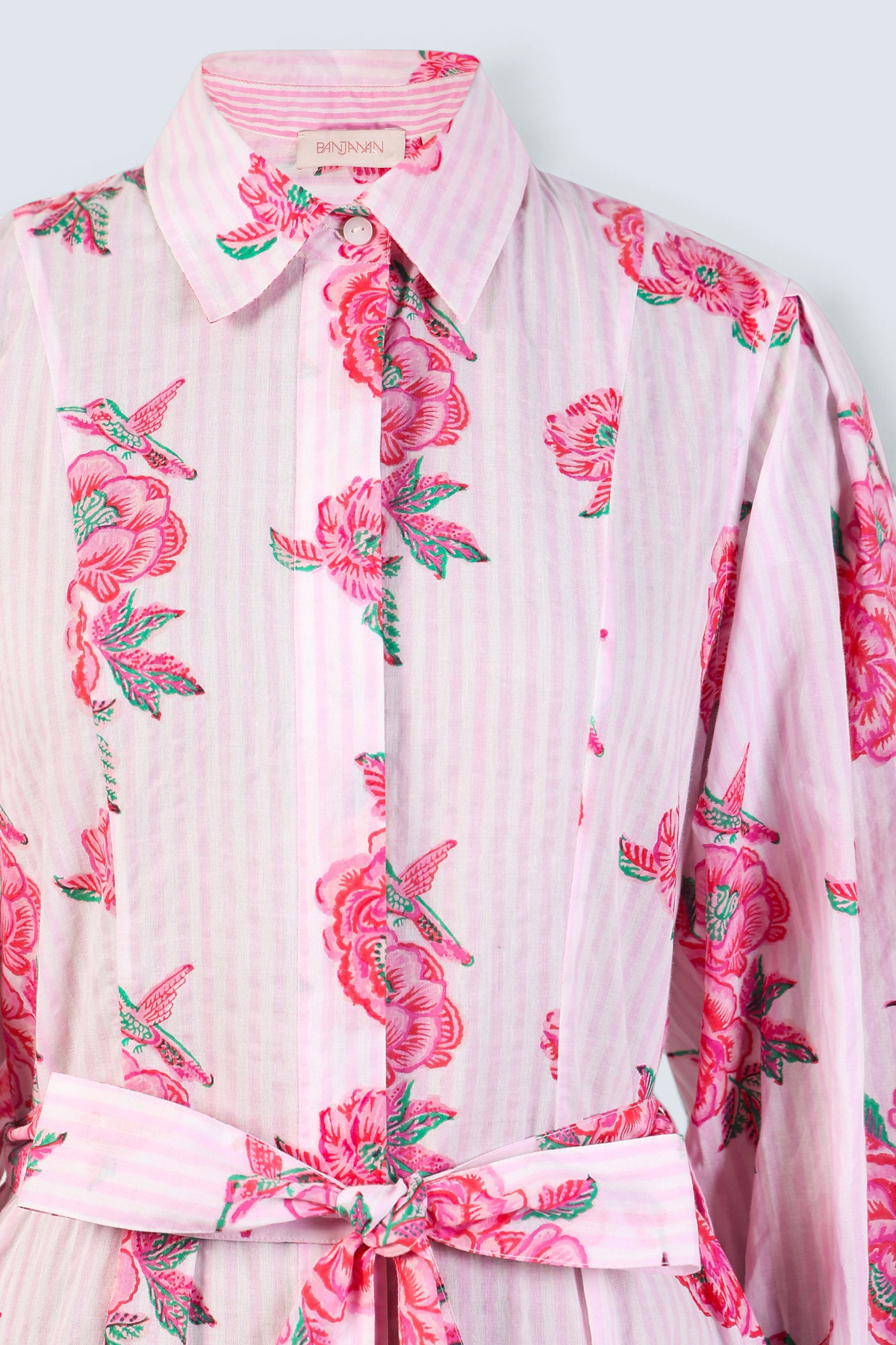 Front view close up the Harris fitted shirtdress in striped cotton with rose and hummingbird block print, tie belt.