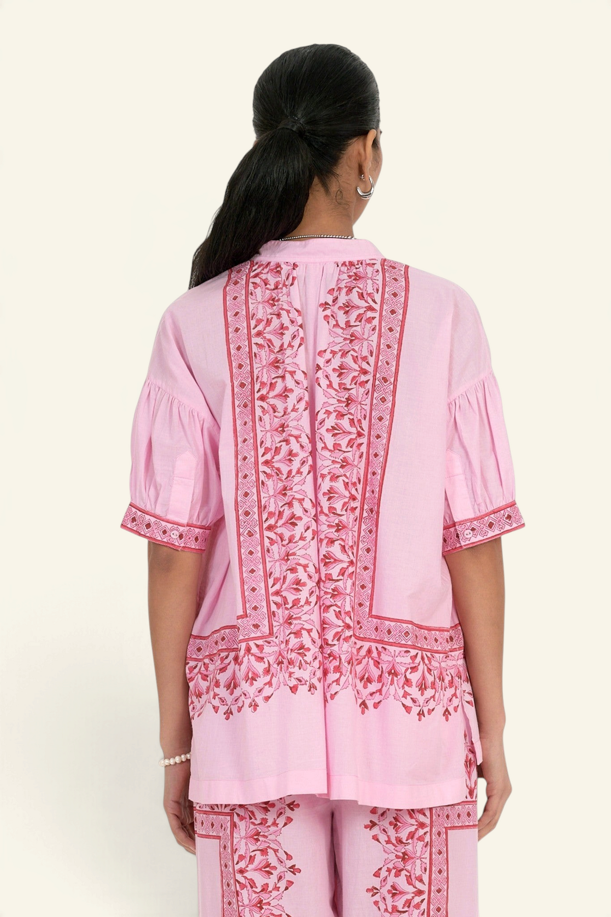Banjanan Ivy shirt in pink cotton cambric with hand-block printed geometric floral patterns and gathered sleeves.