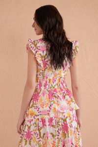 Back view of a woman wearing a sleeveless, floral printed top with ruffle sleeves, smocked waist, and peplum hem in shades of pink, orange, and green. Back view of a woman wearing a sleeveless, floral printed top with ruffle sleeves, smocked waist, and peplum hem in shades of pink, orange, and green.