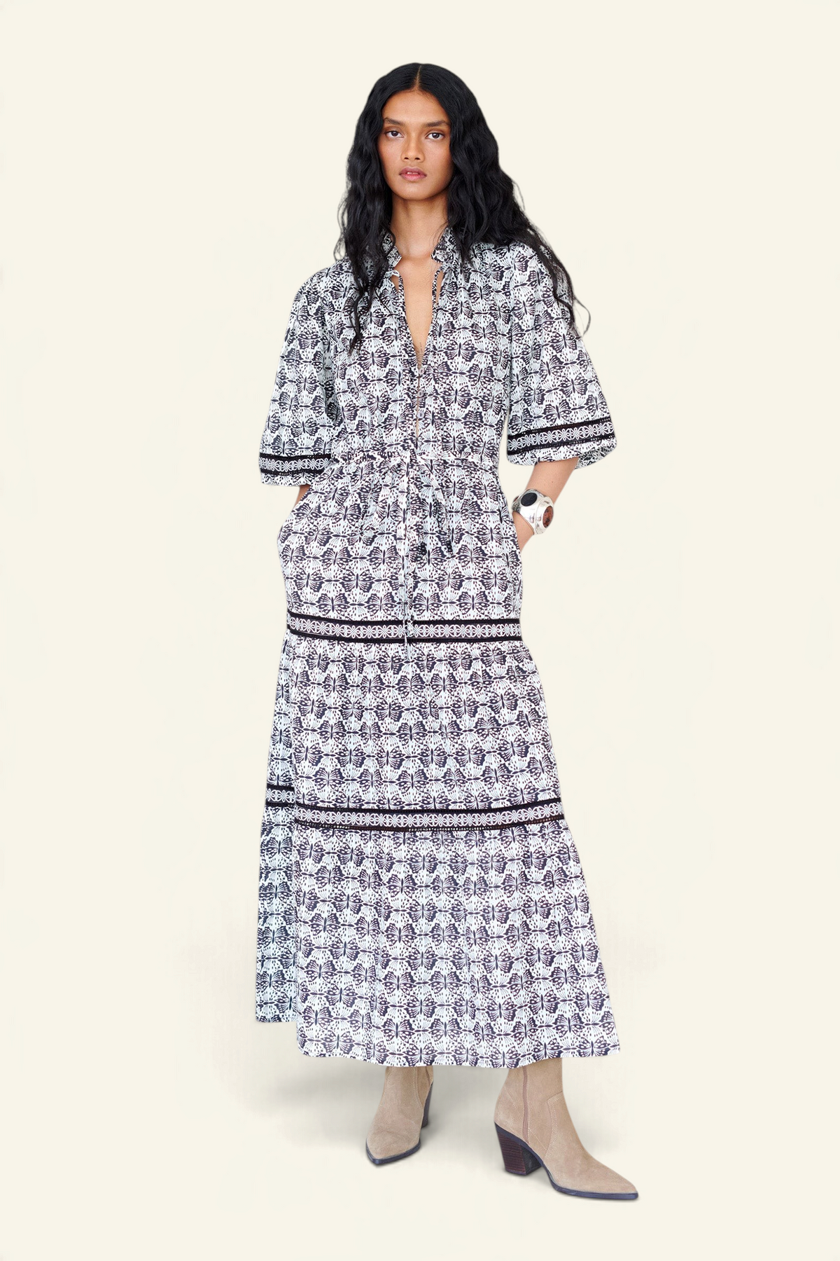 Woman wearing a black and white patterned dress on a white background
