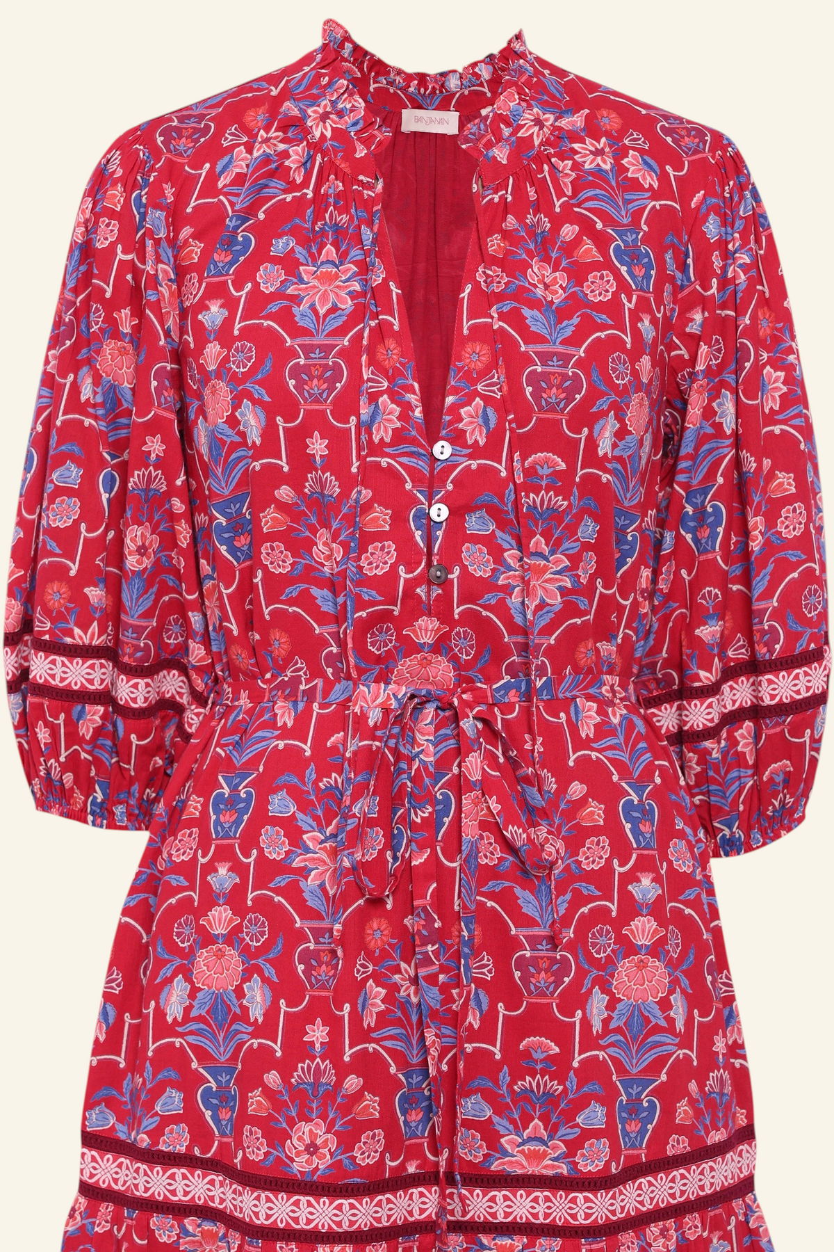 Front view close up of the Liza dress in Floral Vase print. It features a tie neckline, soft ruffles, lace sleeve and a fabric belt.