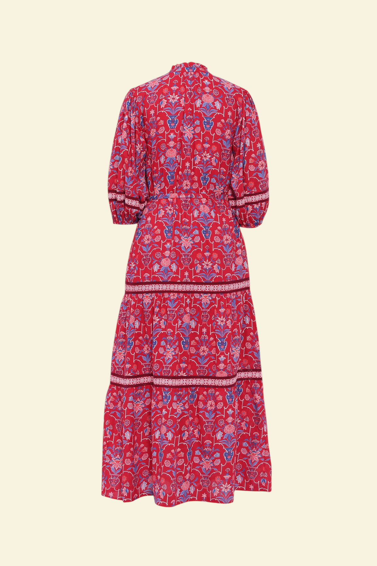 Back view of the Liza dress in Floral Vase print. It features a tie neckline, soft ruffles, lace sleeve and skirt details, and a fabric belt.