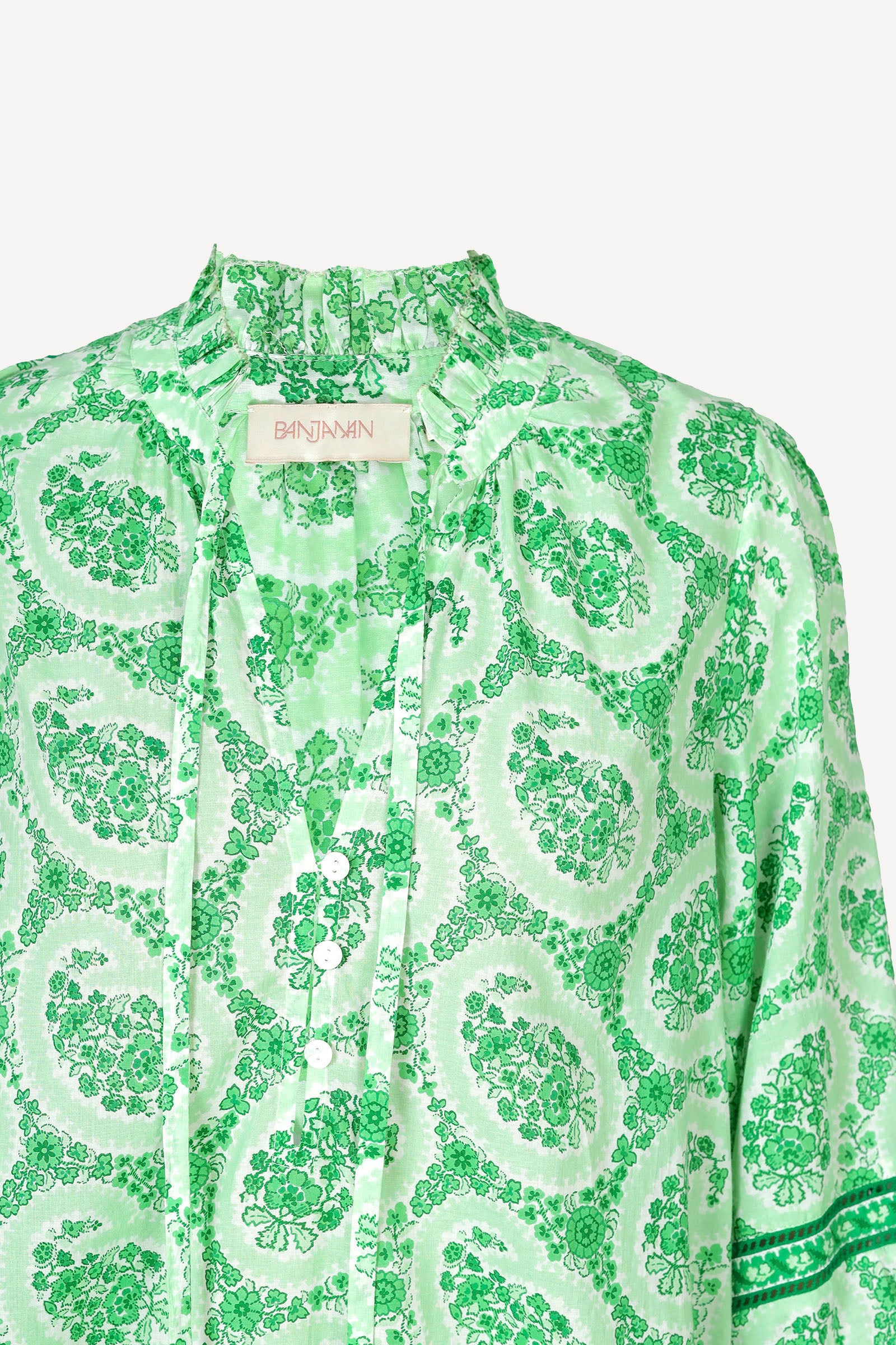 Ghost image of a green paisley Lorna blouse with ruffled tie neckline, button front, and contrast-trimmed sleeves.