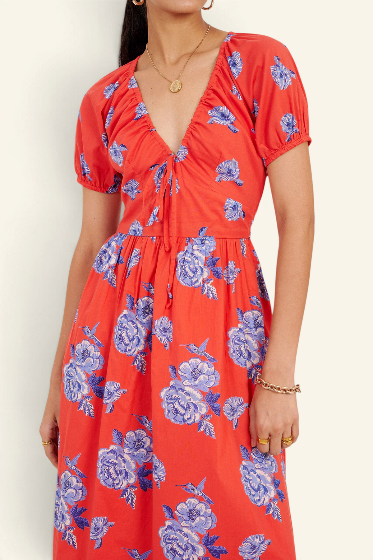 Banjanan Norma dress in poppy red with blue floral rose and hummingbird print, featuring a drawstring neckline.