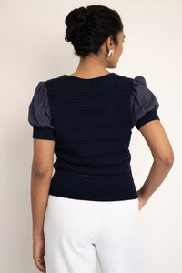 Back view close up of model wearing our Patti V neck oxford with right hand in pocket. Back view close up of model wearing our Patti V neck oxford with right hand in pocket.