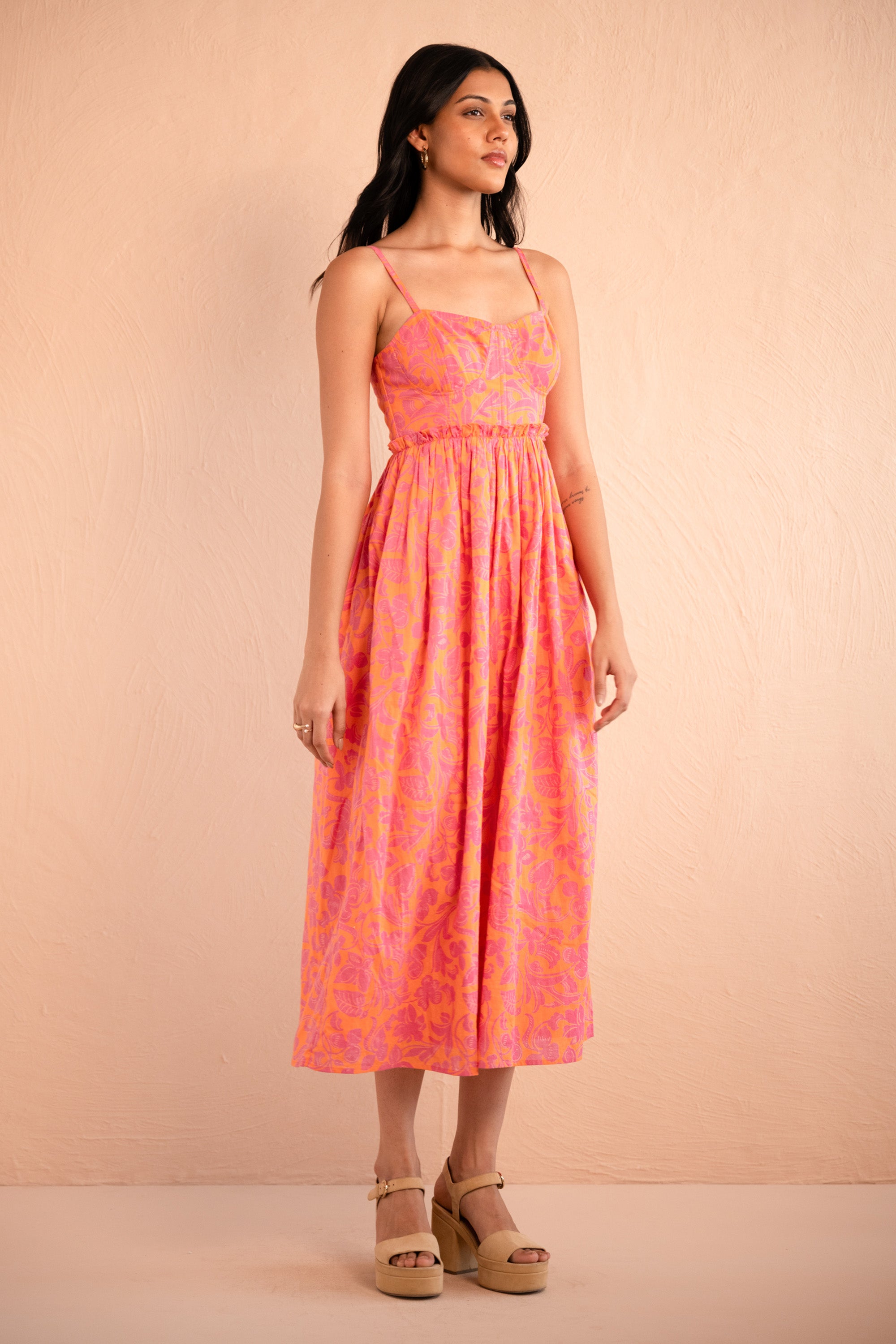 Front side view of model posing wearing Phoebe Dress in Gaia Nectarine print. Front side view of model posing wearing Phoebe Dress in Gaia Nectarine print.