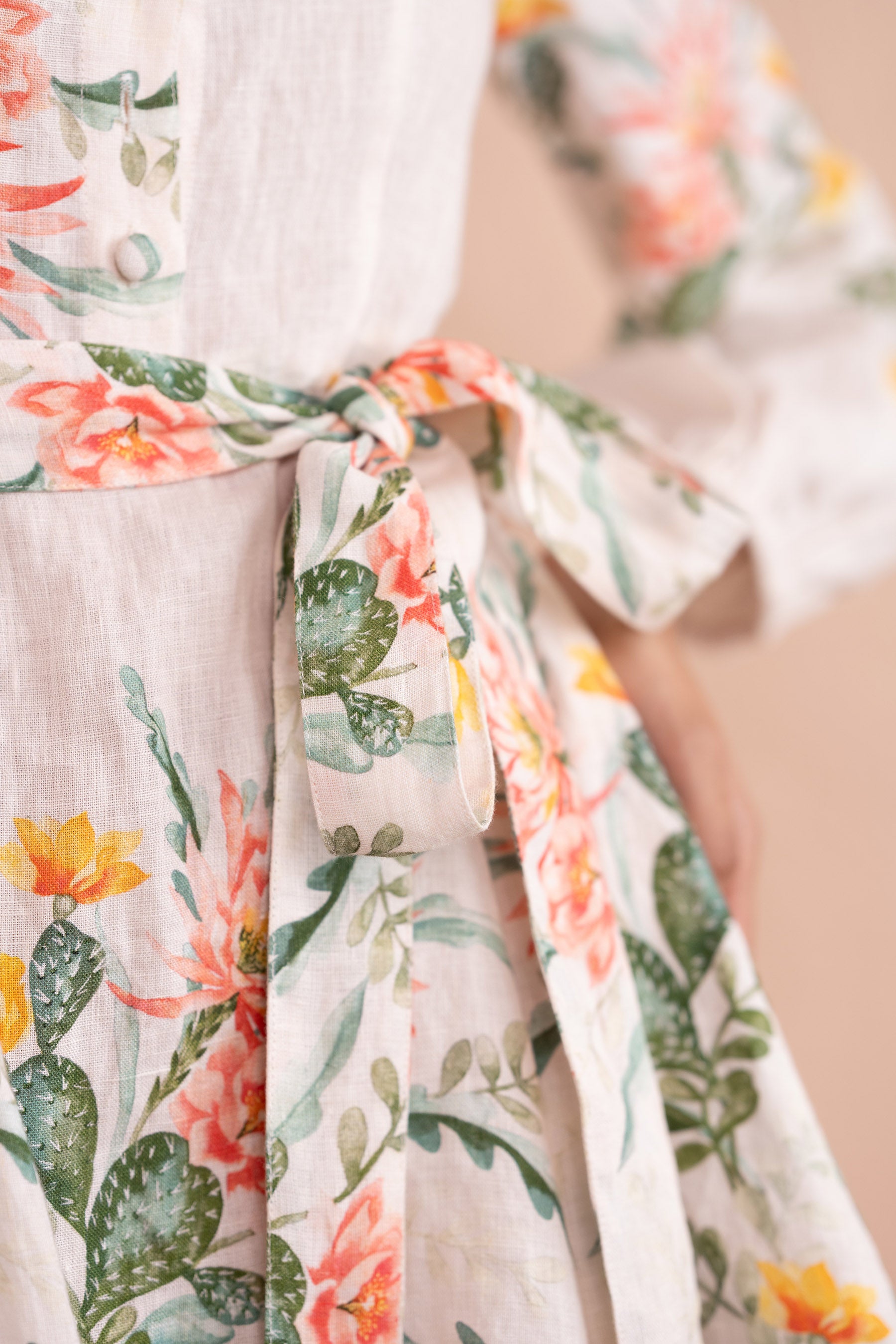Close up detail of belt of Rowena Dress in Desert Rose Dawn print. Close up detail of belt of Rowena Dress in Desert Rose Dawn print.