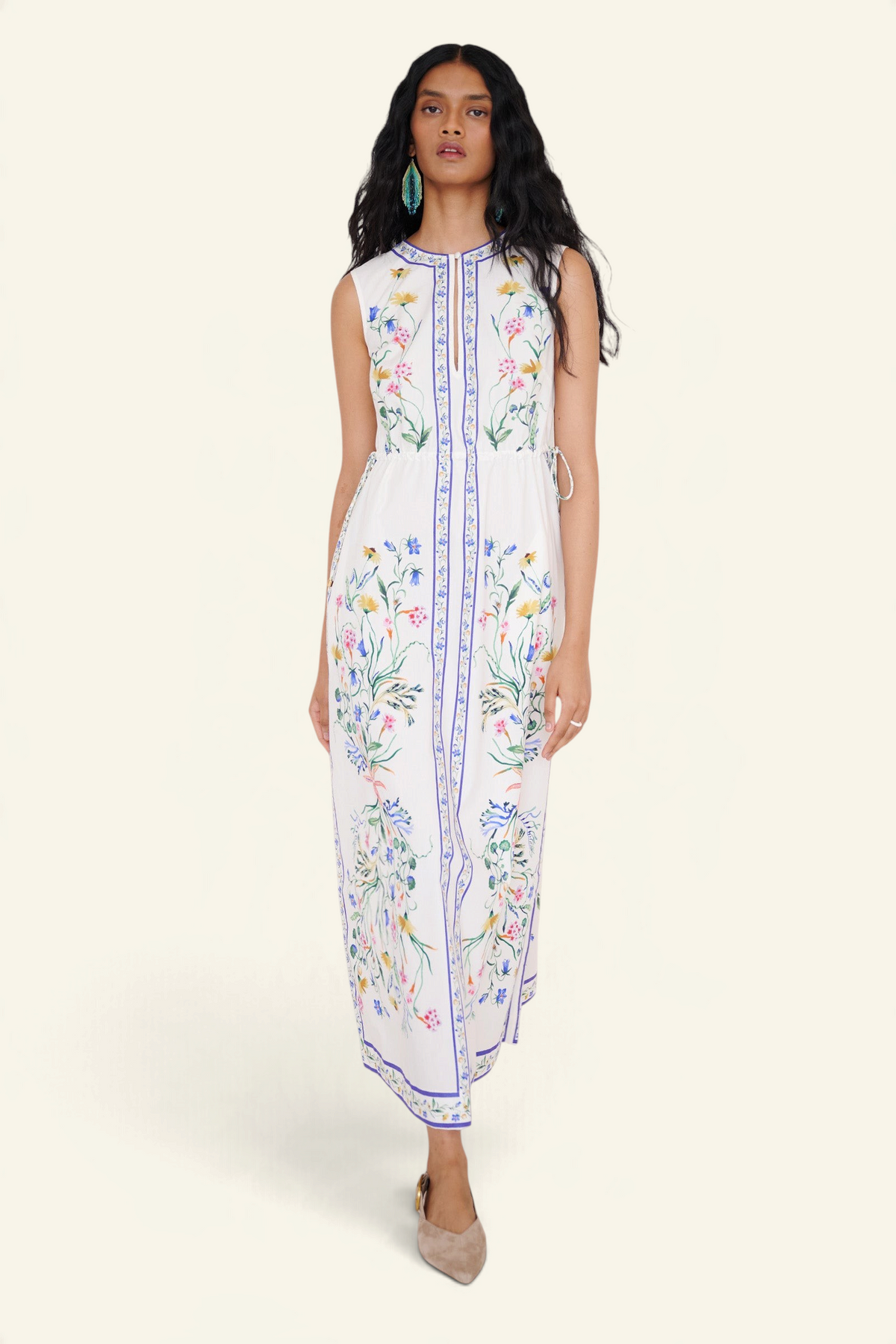Front view of a woman walking wearing the Rhonda column dress in Tidepool print, featuring side drawstrings with gold caps, front keyhole button, and side-seam pockets.