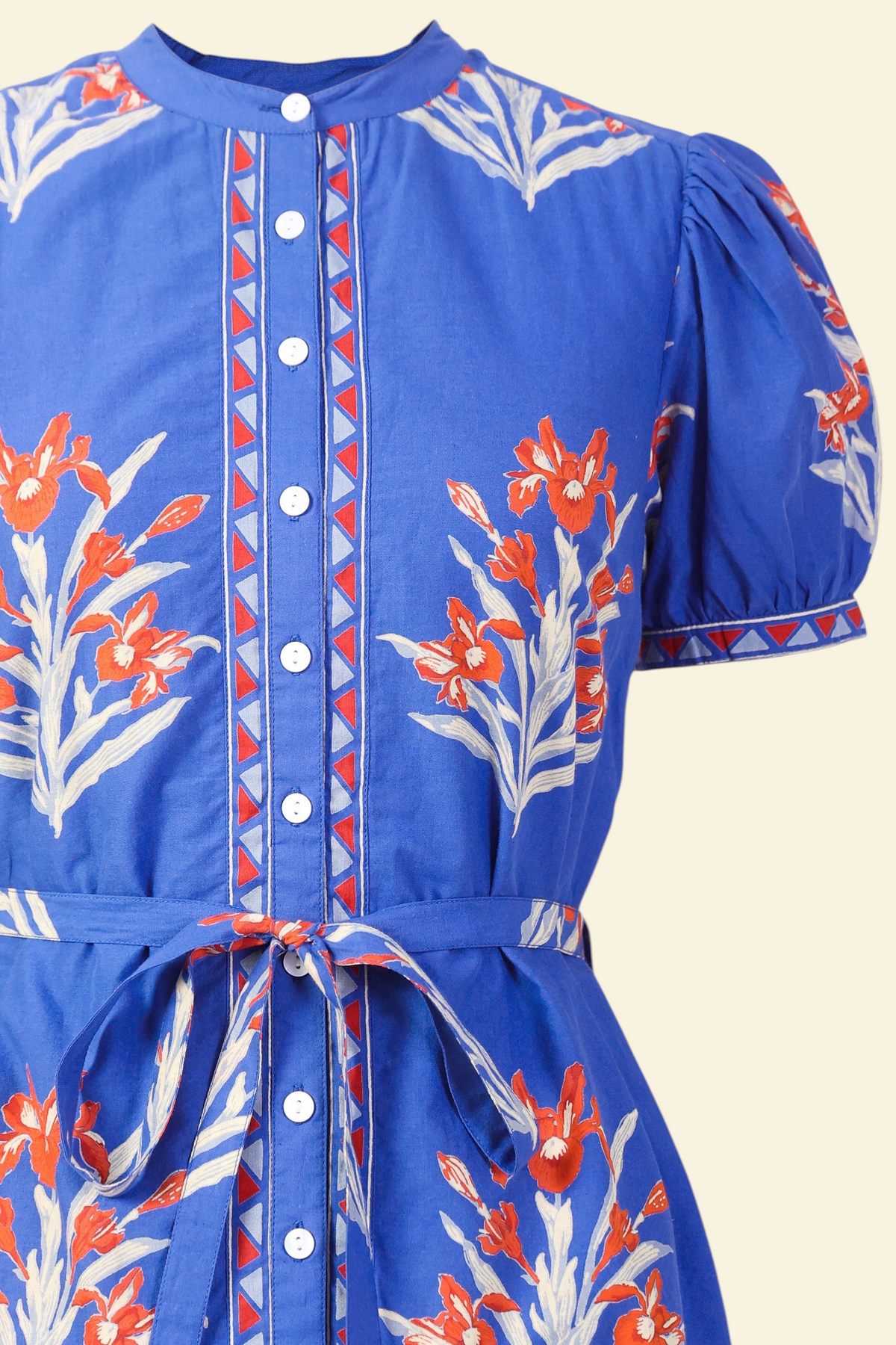 Front view close up of a woman standing wearing the Saylor dress in Brigitte print. It features detachable belt, and classic shirtdress silhouette in hand-screen-printed cotton voile.