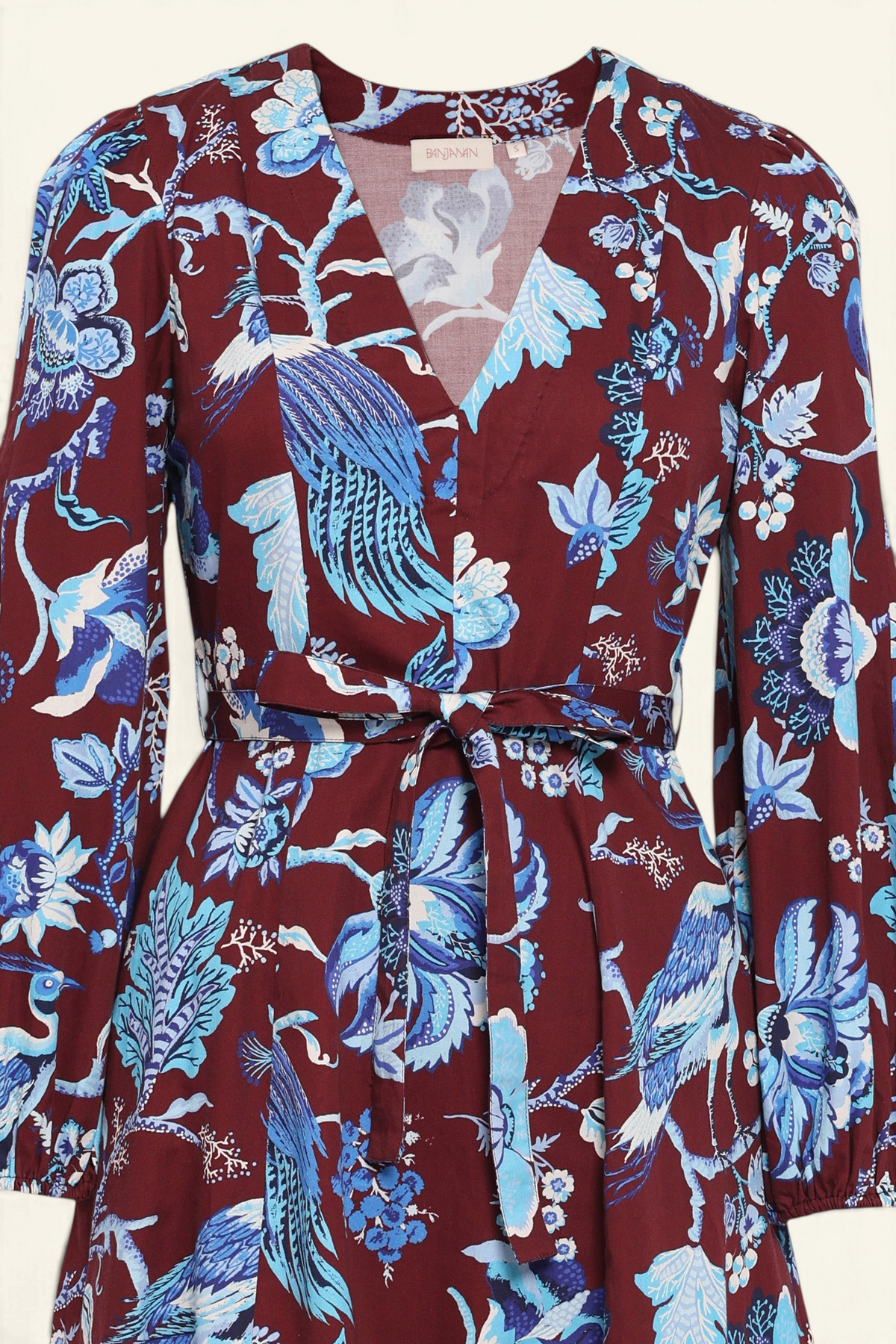 Front view close up the Zora dress in Chintz print, featuring a V-neck, lantern sleeves, princess seams, a gathered fit-and-flare skirt, fabric belt, and side-seam pockets.