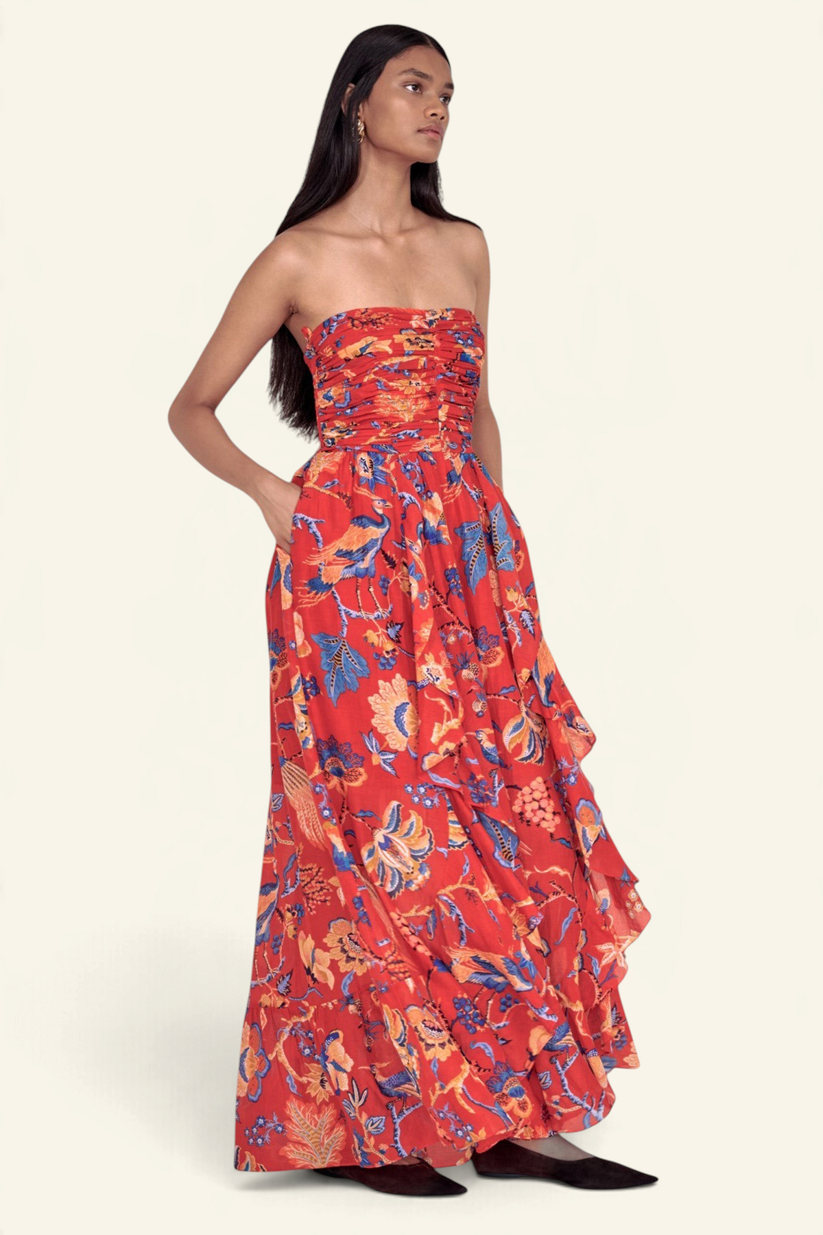 Banjanan Bella dress in red Chintz print cotton silk with a ruched bodice, cascading skirt, and side pockets.