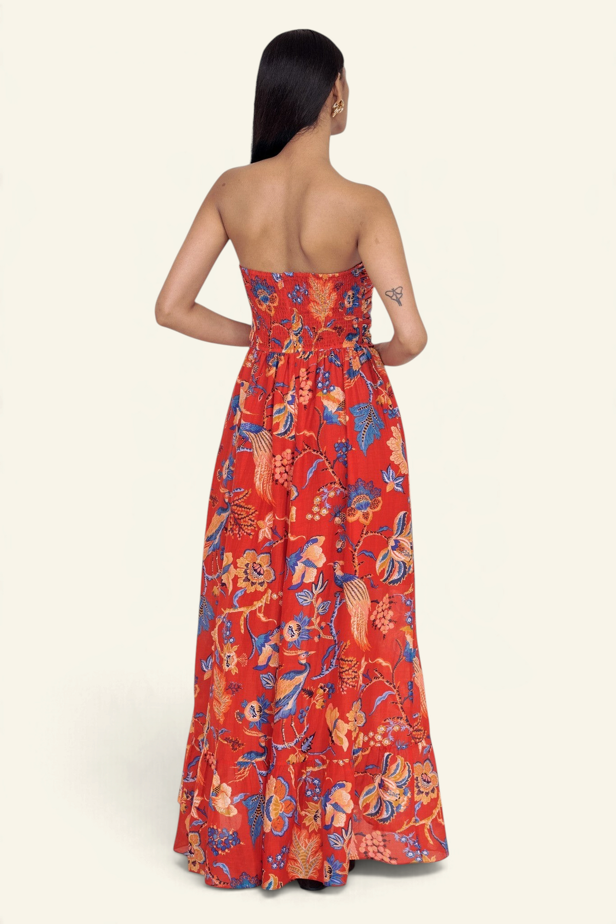 Banjanan Bella dress in red Chintz print cotton silk with a smocked back and full-length cascading skirt, back view.