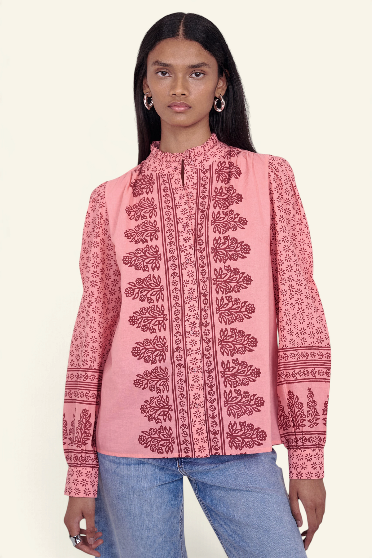 Banjanan Christina shirt in azalea pink with hand-blocked floral print, frilled stand collar, and puffed sleeves.