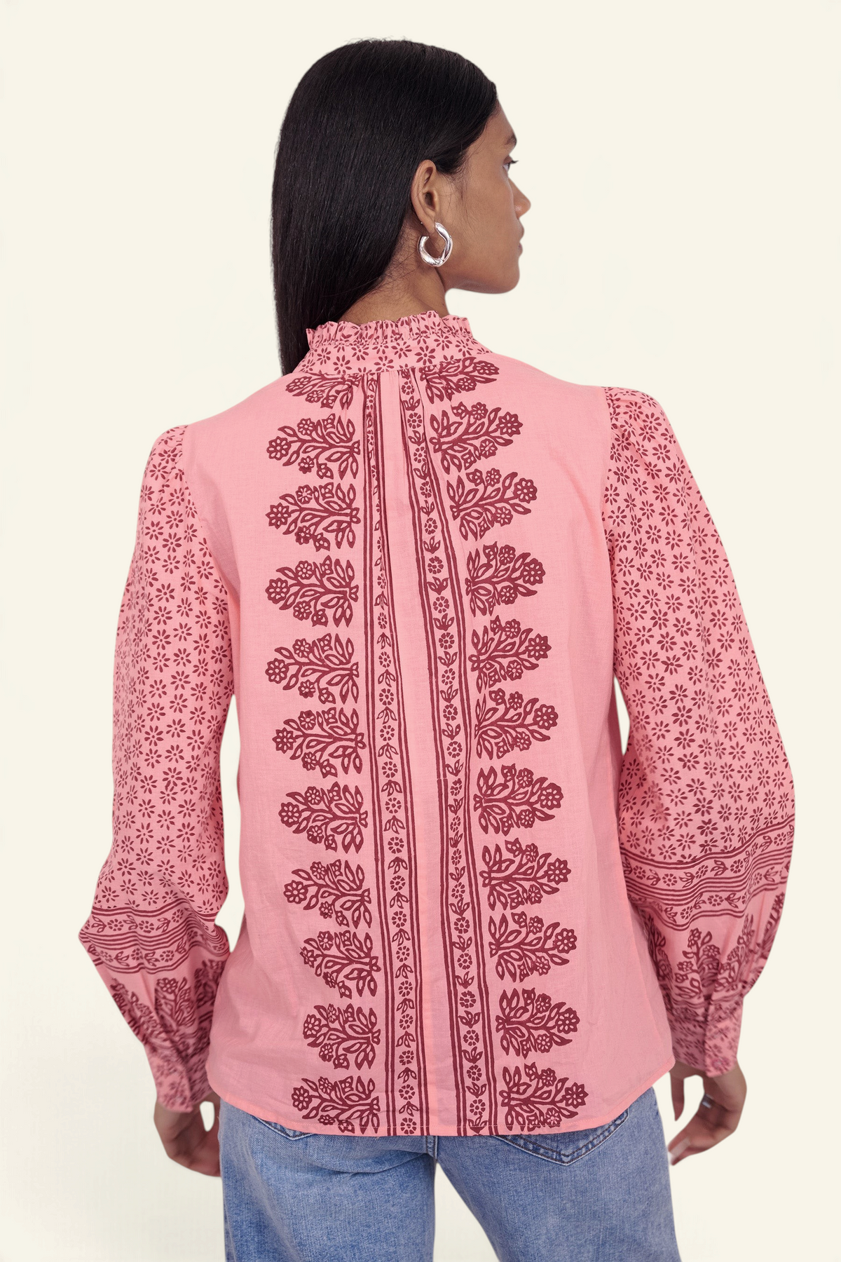 Banjanan Christina shirt in azalea pink with hand-blocked geometric floral print, frilled collar, and puffed sleeves.