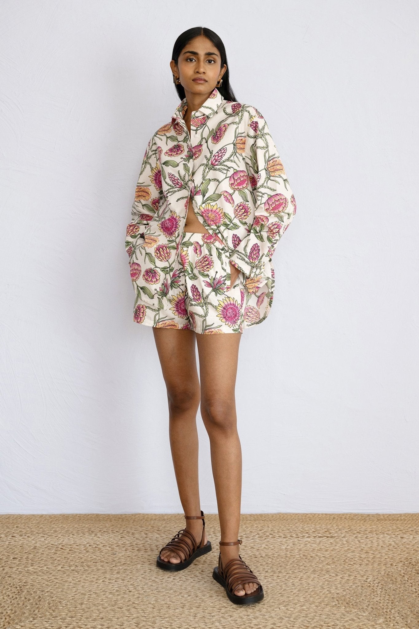 Front view of model standing Evelyn Shorts Protea Cypress paired with Charlotte shirt in same print.