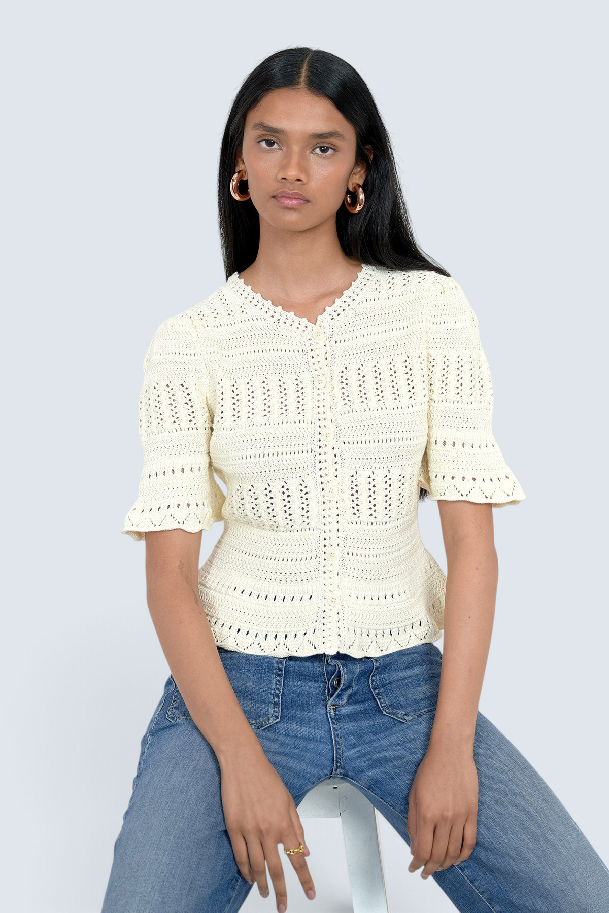 Banjanan ivory short sleeve cotton cardigan with intricate hand-crocheted trim and front button placket