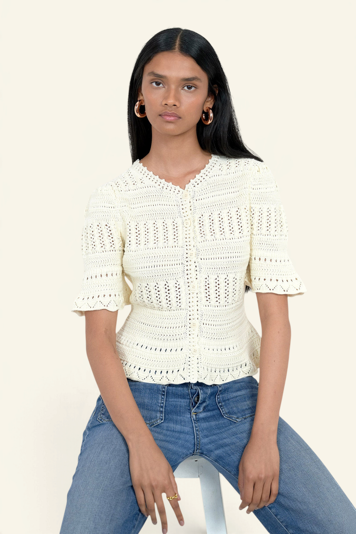 Banjanan ivory short sleeve cotton cardigan with intricate hand-crocheted trim and front button placket