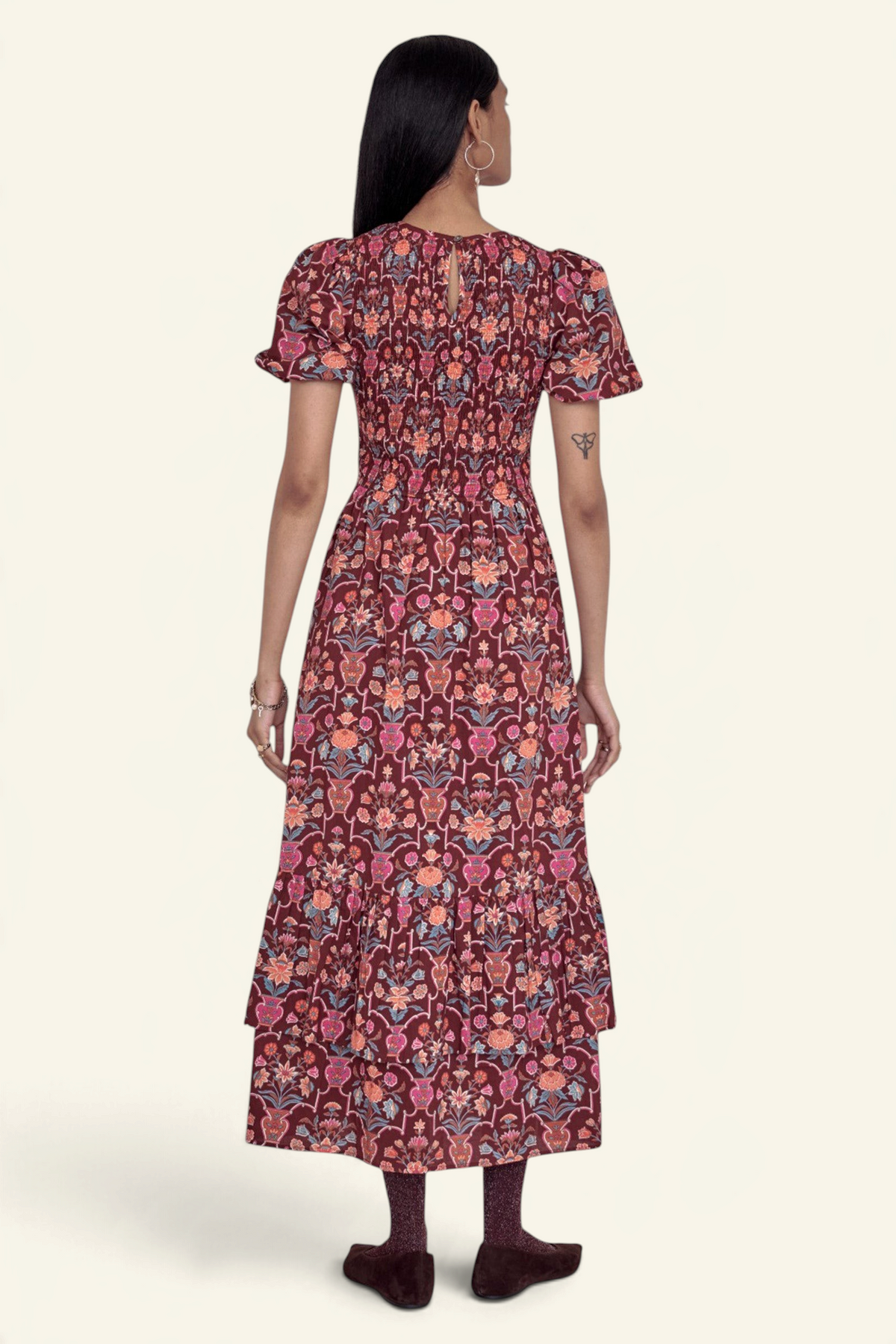 Back view of a Banjanan Quant dress in chestnut floral vase print with smocked bodice and tiered midi skirt.