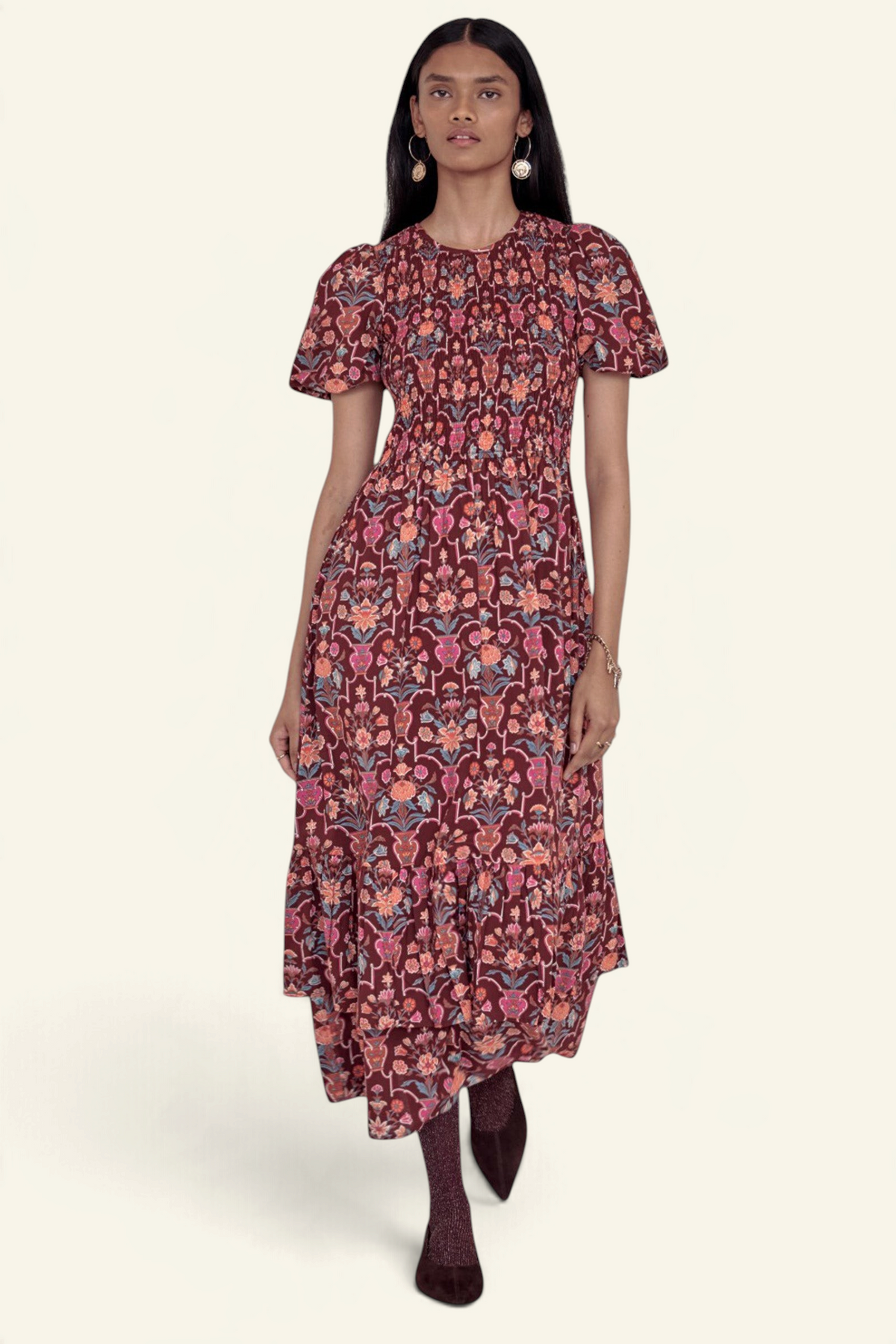 Banjanan Quant dress in chestnut floral vase print with smocked bodice, puffed sleeves, and tiered midi skirt.