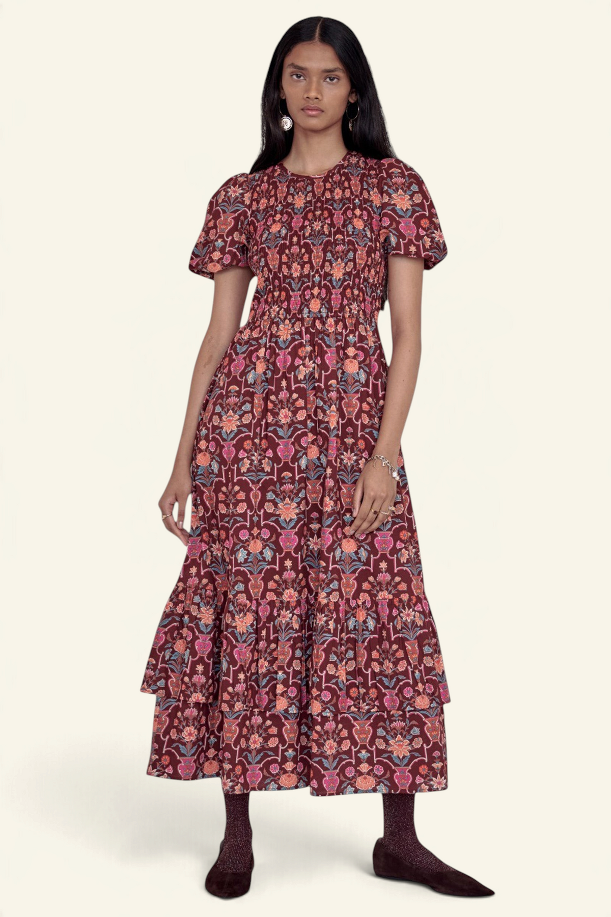 Banjanan Quant dress in chestnut floral vase print with smocked bodice, puffed sleeves, and tiered midi skirt.