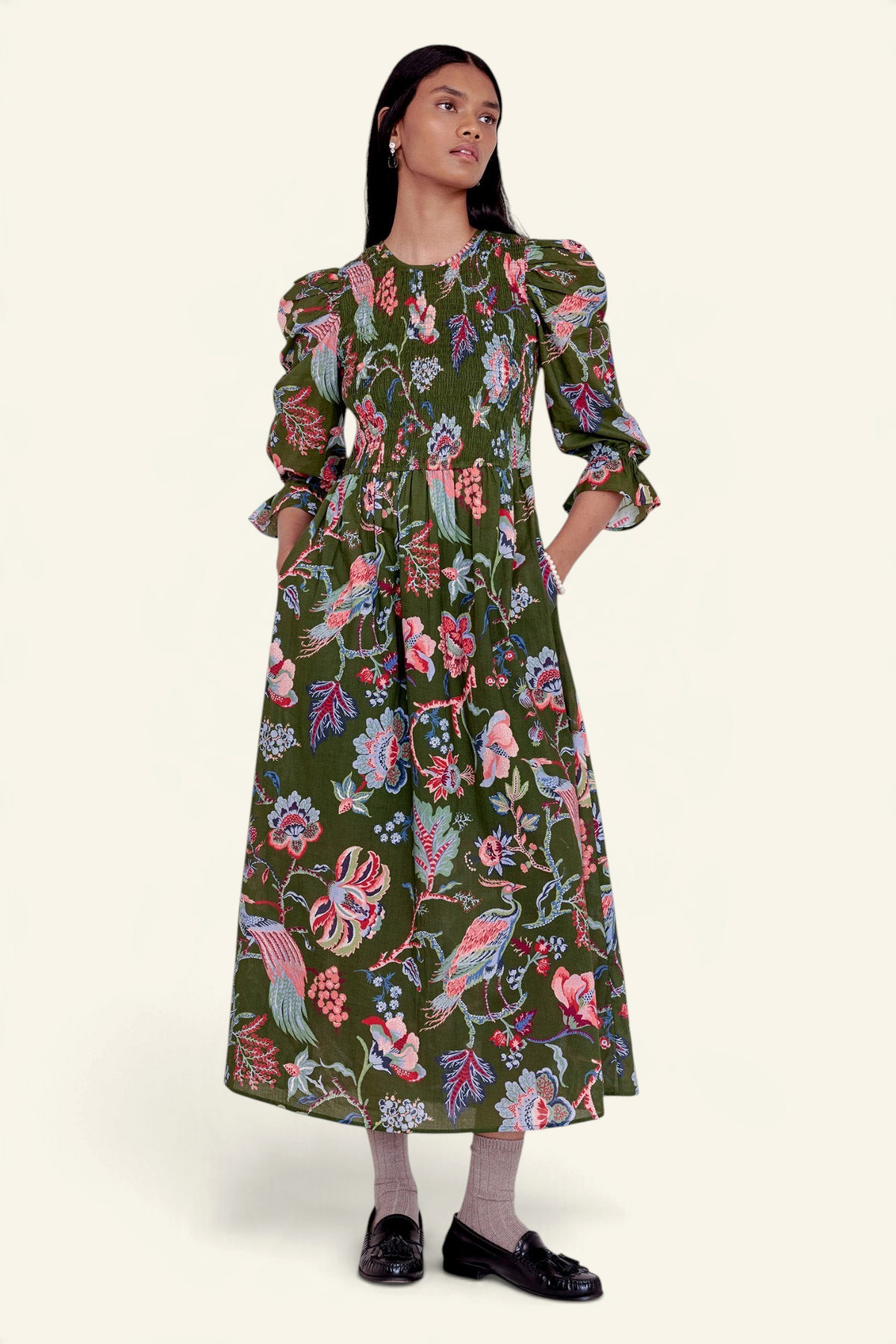 Banjanan Queenie dress in moss green chintz floral print with smocked bodice, puff sleeves, and side pockets.