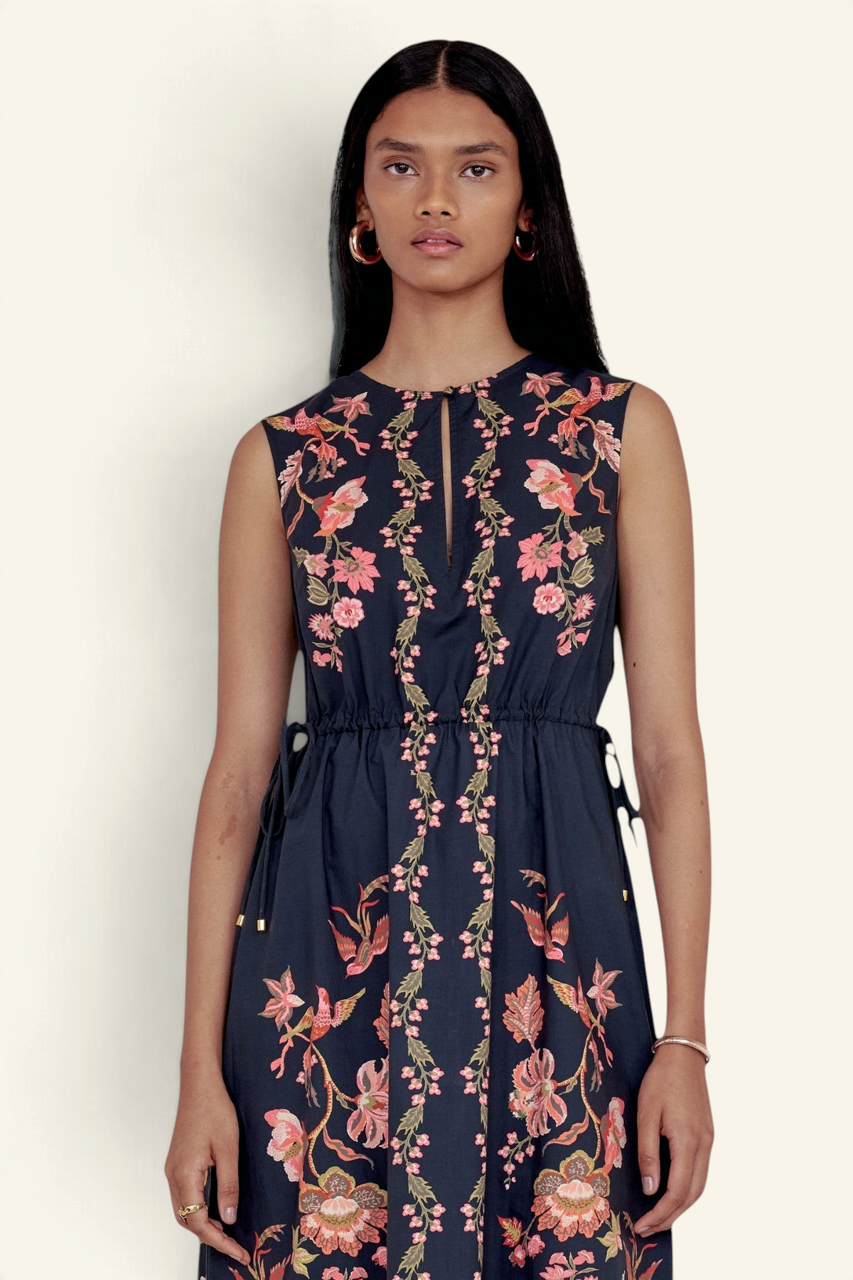 Banjanan Rhonda column dress in jet black with floral and bird print, crewneck keyhole, and drawstring waist.