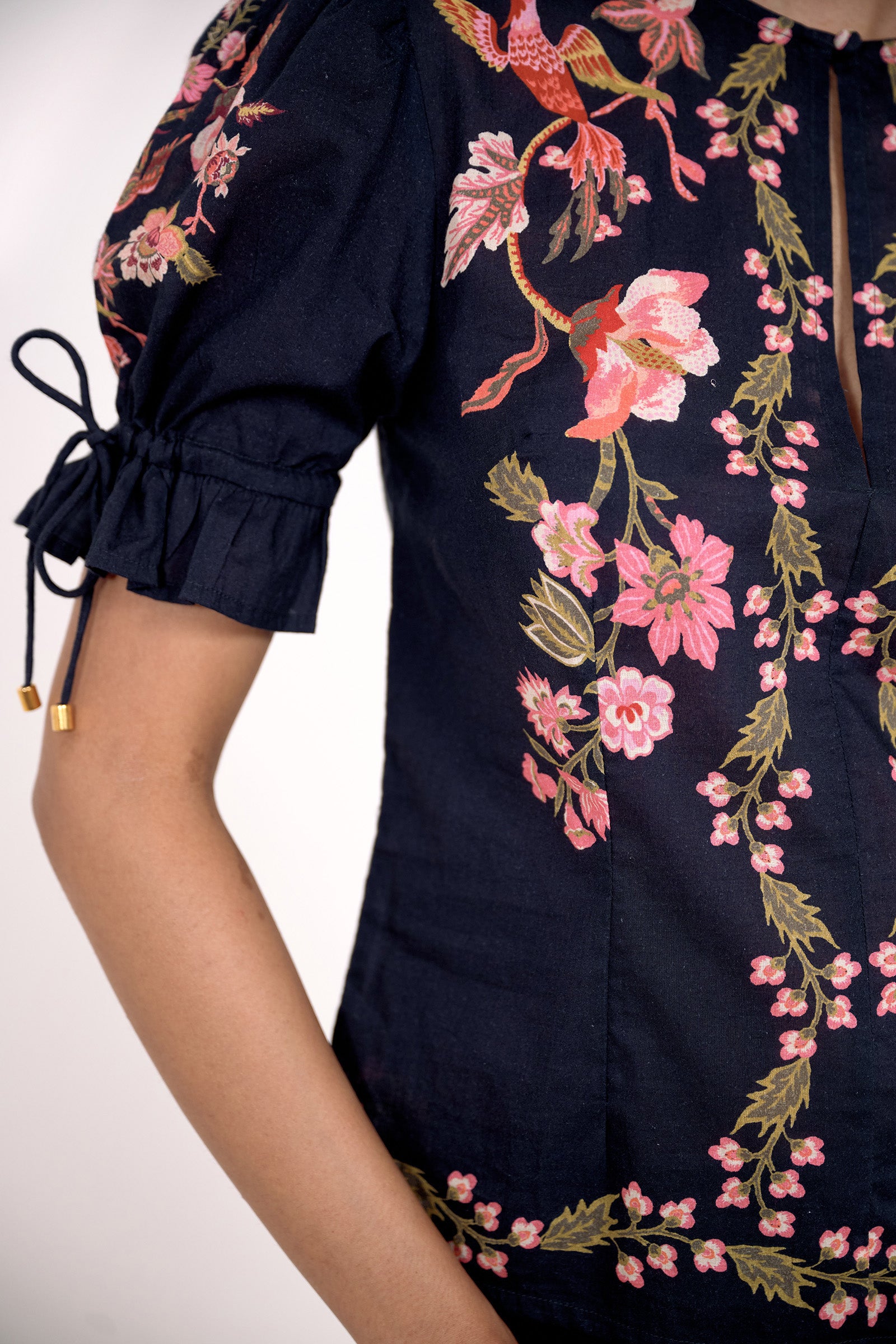 Close up of the Ricki top in Chintz print, featuring adjustable drawstring sleeves, and vintage-inspired print placement.