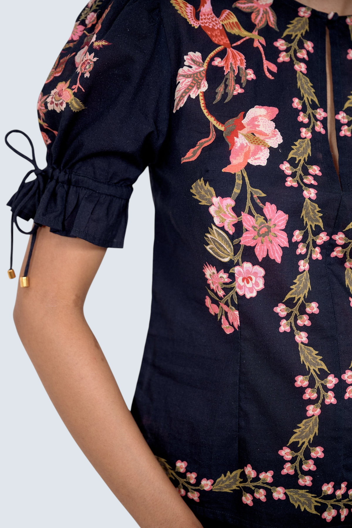 Close up of the Ricki top in Chintz print, featuring adjustable drawstring sleeves, and vintage-inspired print placement.
