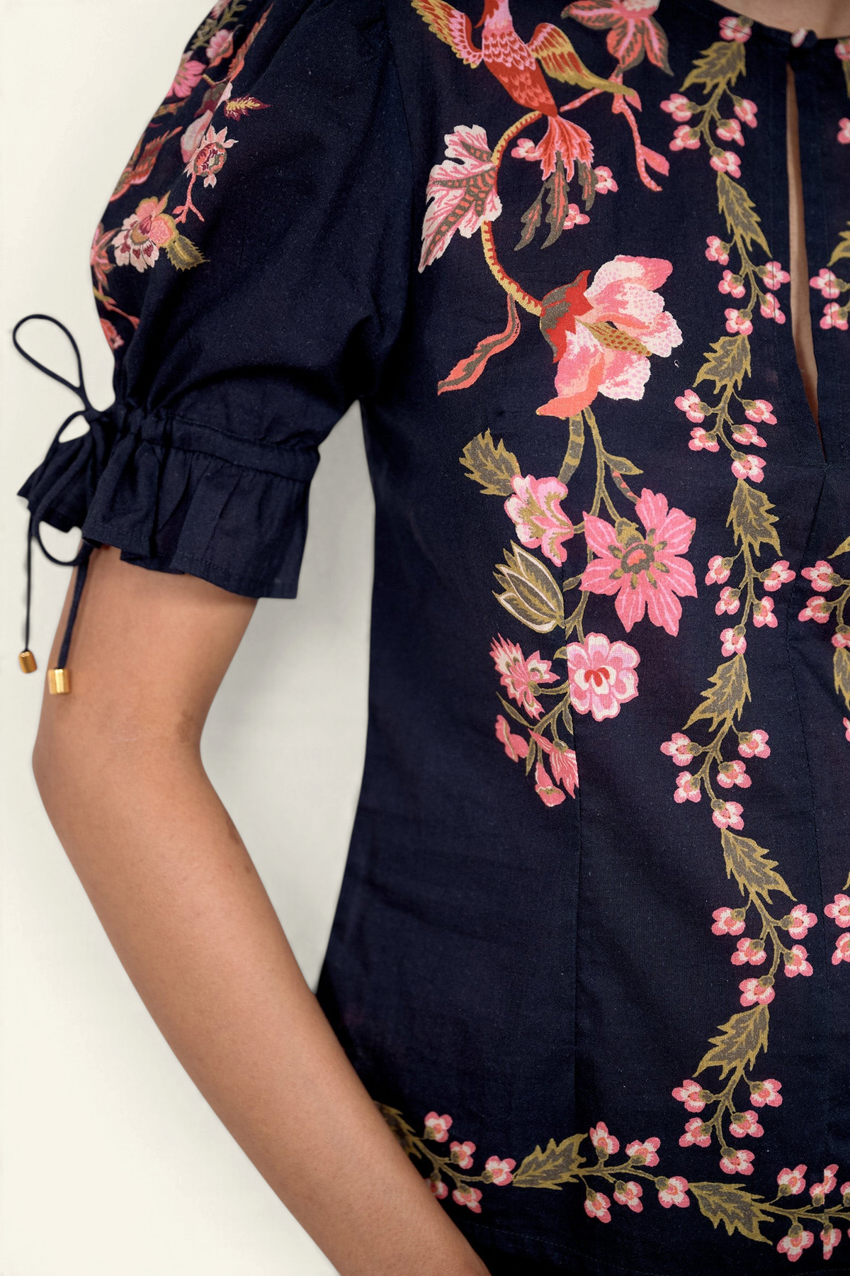 Close up of the Ricki top in Chintz print, featuring adjustable drawstring sleeves, and vintage-inspired print placement.