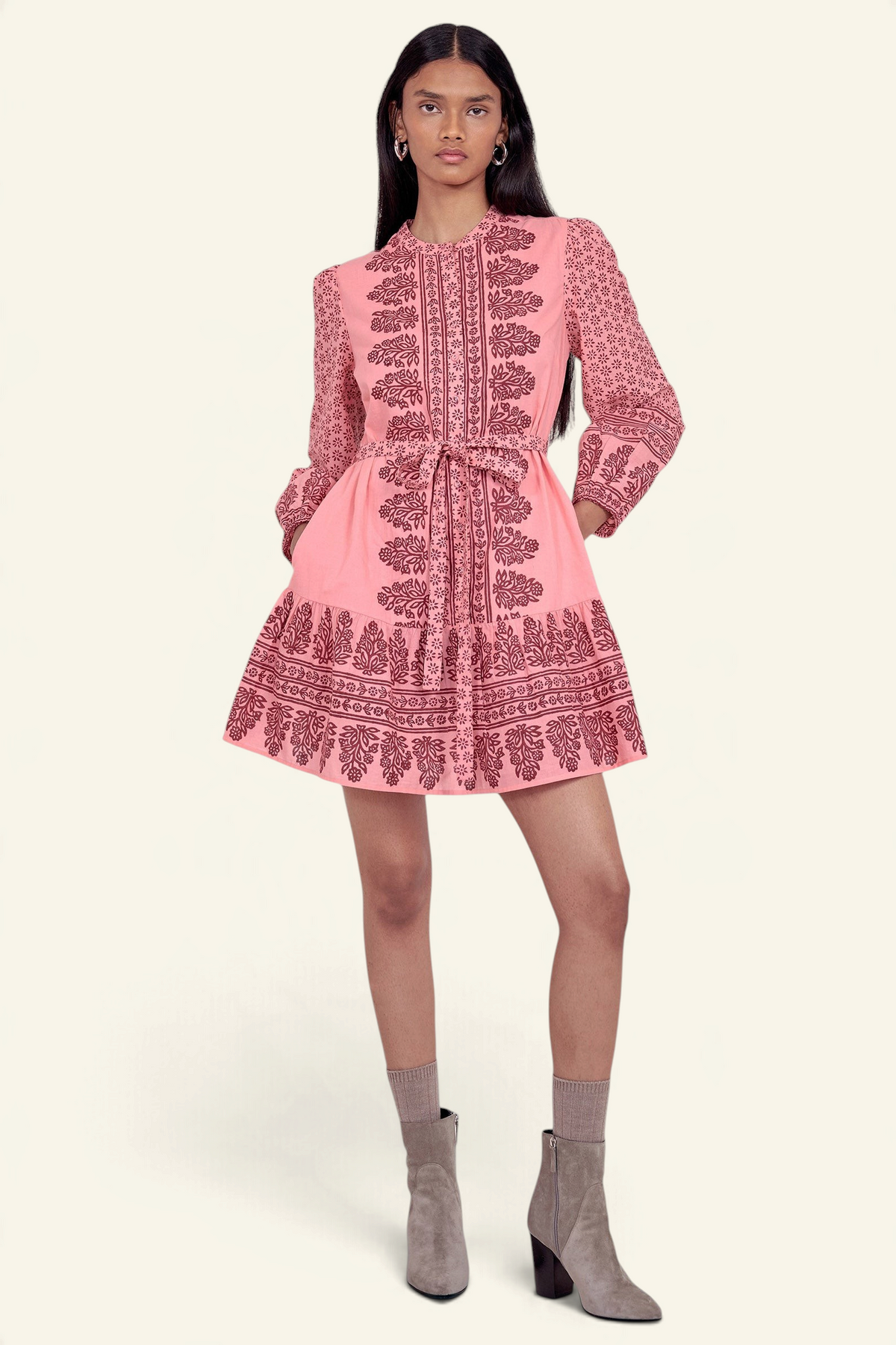 Front view of model standing wearing the Roma dress in Eugenie print, featuring a mini length, wrist-length sleeves, a detachable belt, and side-seam pockets.