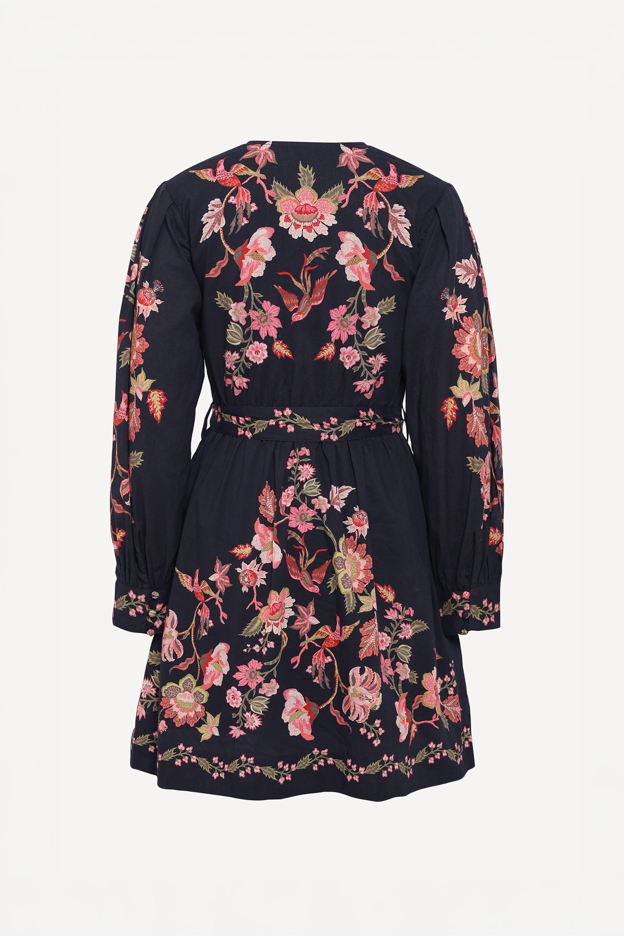 Back view of the Anne dress in Chintz print. It features long sleeves, an elasticated waist, fabric-covered buttons, a fabric belt, and side-seam pockets.