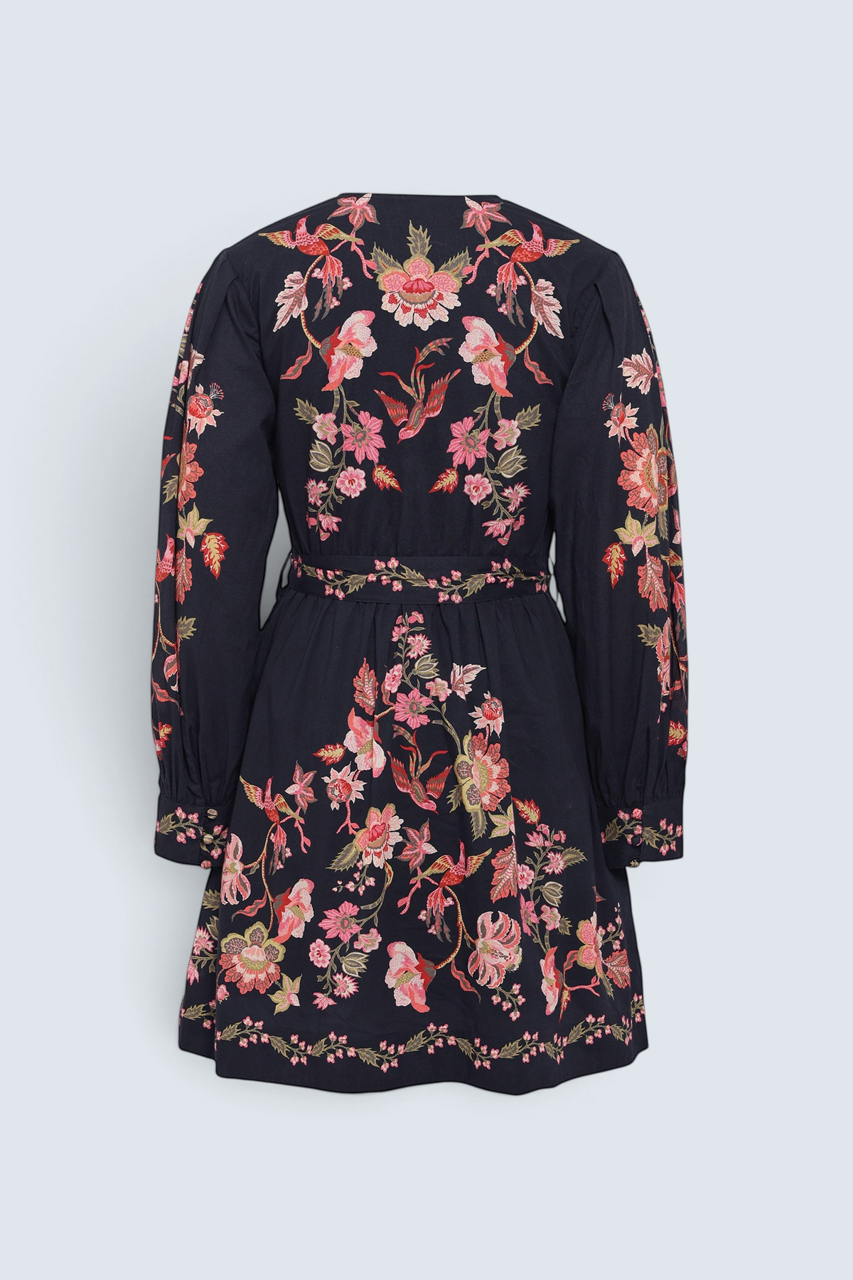 Back view of the Anne dress in Chintz print. It features long sleeves, an elasticated waist, fabric-covered buttons, a fabric belt, and side-seam pockets.