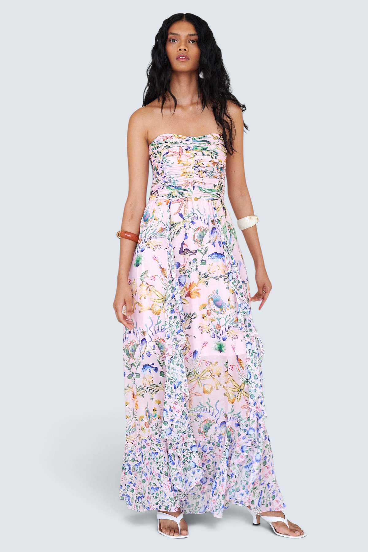 Banjanan Bella dress in Tidepool Conch print featuring a strapless ruched bodice and cascading ruffled skirt.
