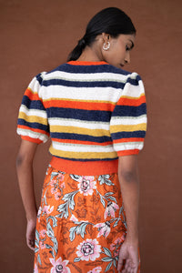 Back view of a woman wearing the Brushed Stripe Cardigan, which hits at the waist, featuring a button placket, ribbed trim, and soft brushed yarn finish.