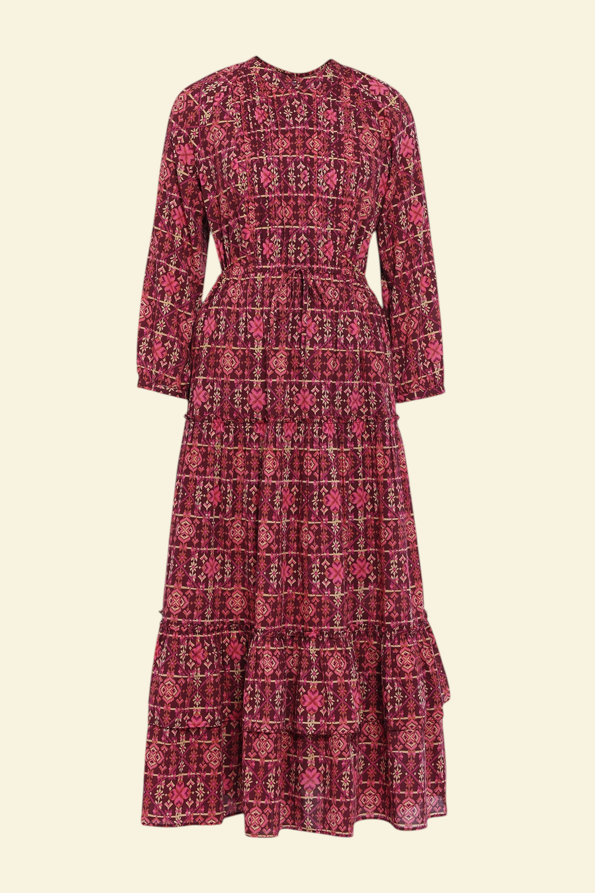 Banjanan Bazaar dress in mahogany cotton voile with a geometric needlepoint floral print, long sleeves, and tiers.