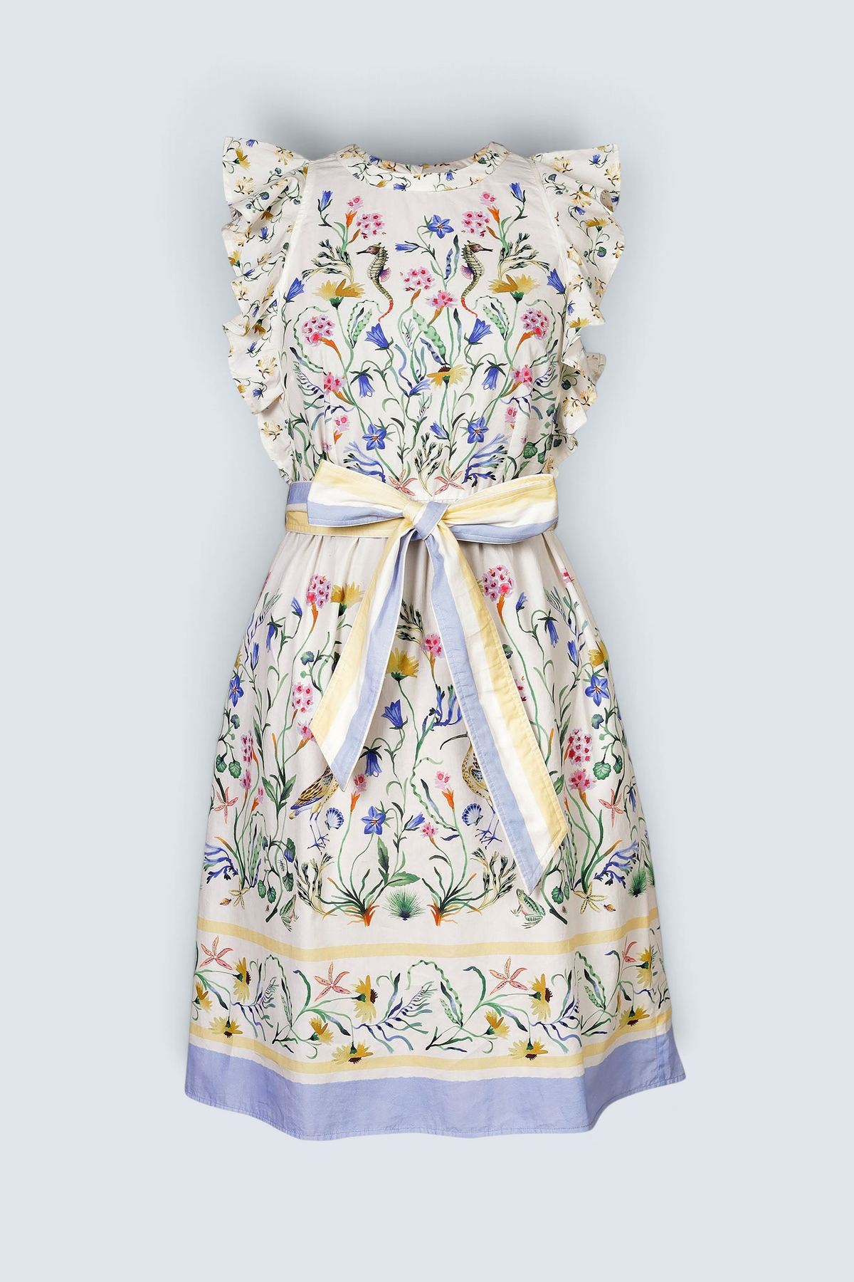 Banjanan Bulbul dress in Tidepool Grotto print with ruffled shoulders, floral pattern, and blue and yellow stripe belt.