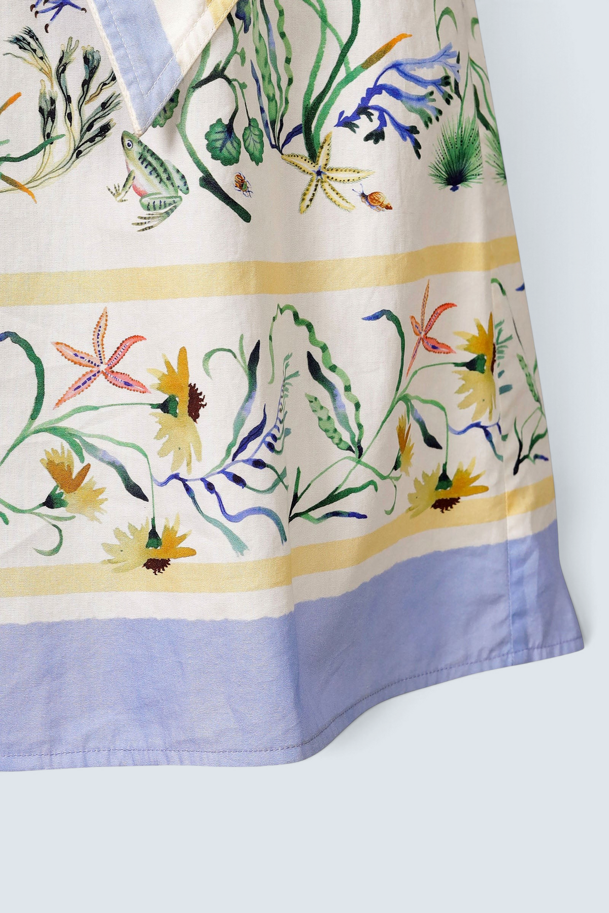 Banjanan Bulbul dress in Tidepool Grotto print featuring seahorses, wildflowers, and blue and yellow striped trim.