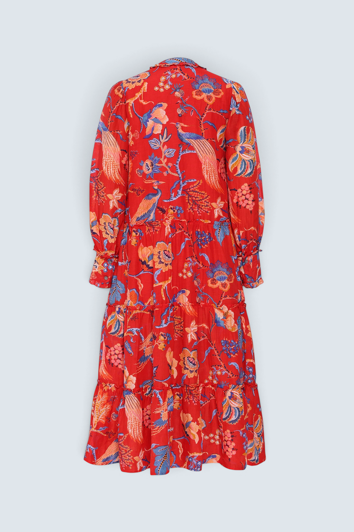 Back view of the Emira dress in Chintz print. It  features a flowing skirt, delicate ruffles, fabric-covered buttons, and a detachable belt.
